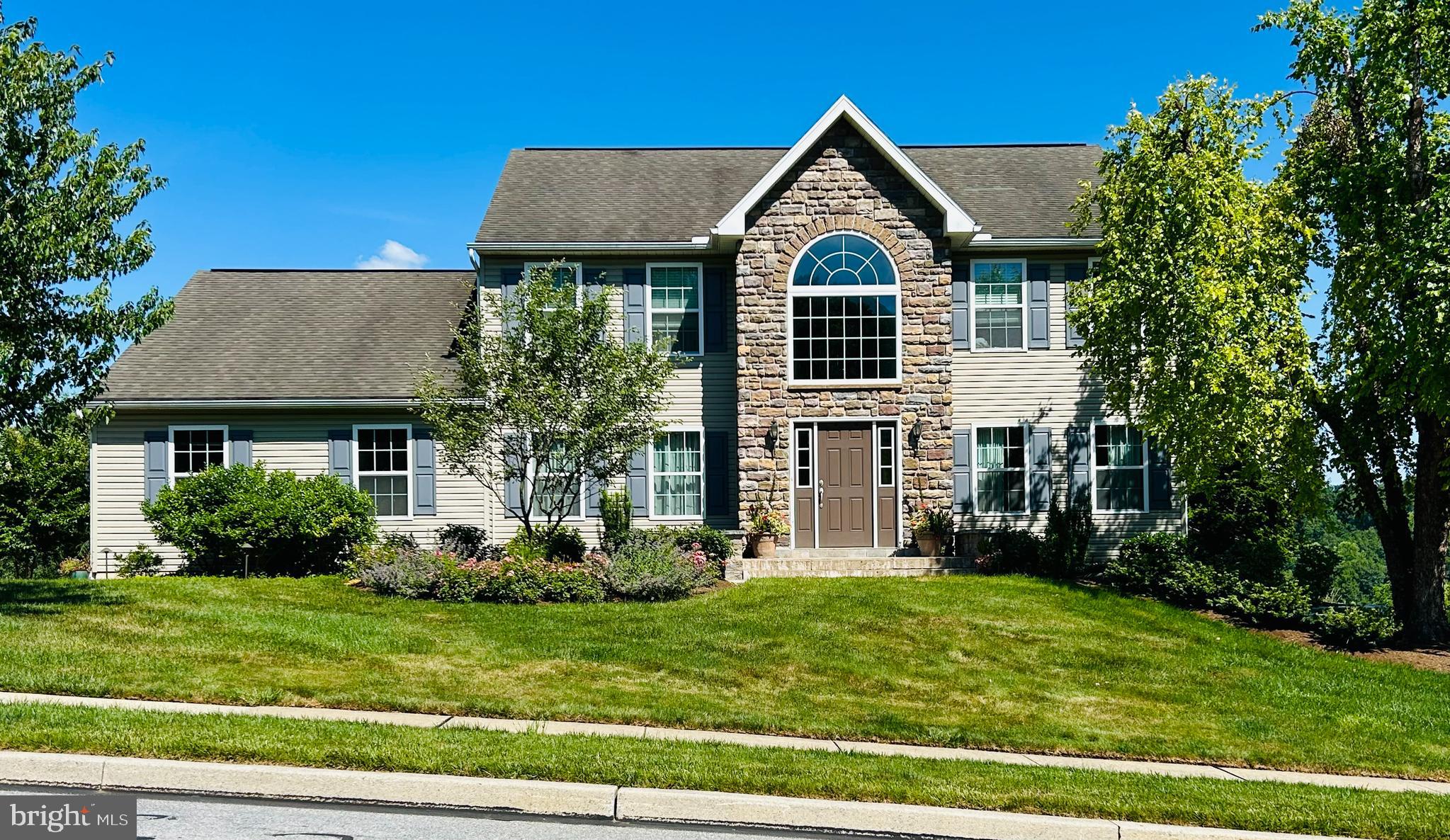 Welcome to this beautifully maintained 4-bedroom, 2.5-bath center hall colonial, ideally situated in the highly desirable neighborhood of Governor's Pointe in Governor Mifflin School District. Combining timeless elegance with modern updates, this home offers spacious living, thoughtful design, and breathtaking outdoor views. Step inside the impressive two-story foyer with soaring cathedral ceilings that create a grand first impression. The main level features a versatile bonus sitting room—perfect as a home office, playroom, or formal living room — alongside a spacious family room, formal dining room, convenient main-floor laundry, and powder room. The updated eat-in kitchen offers abundant cabinetry, generous workspace, and seamless access to an expansive rear deck, where you'll enjoy stunning panoramic views ideal for entertaining or just relaxing. Upstairs, the oversized master bedroom suite offers an updated ensuite bath, dedicated dressing area, and a large walk-in closet. Three additional generously sized bedrooms and a full hall bath complete the second floor. The lower level features an oversized unfinished walkout basement with double-door access to a beautiful paver patio and lush backyard, offering endless possibilities for future finished living space, a home gym, or workshop. Outside, professionally designed hardscaping and mature landscaping create exceptional curb appeal and outdoor enjoyment. An attached two-car garage and convenient access to major commuter routes, shopping, dining, and everyday amenities make this exceptional home the complete package. Don't miss the opportunity to own this spacious colonial offering timeless charm, modern comfort, spectacular outdoor living, and an unbeatable location.
