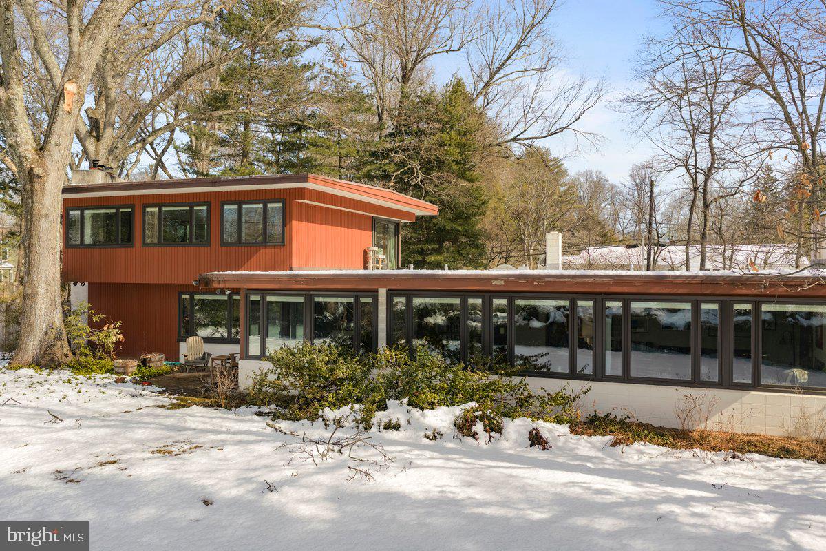 
Step into a world of architectural distinction at 1112 General St. Clair in Washington Crossing, PA 18977. This refined 5-bedroom, 3 and 1 1/2 -bath residence is a rare offering—an authentic Thaddeus Longstreth original custom-built home that artfully preserves its mid-century integrity while embracing thoughtful modern upgrades. ( Processing a few more photos should be up shortly)
Perfectly positioned directly across from Washington Crossing Historic Park and the lagoon, you are literally steps from nature. Walk out your front door and into miles of scenic canal towpath, protected parkland, and enjoy a quick stroll to Washington Crossing Village and the Delaware River. For the discerning nature lover who values privacy, history, and design, this setting is simply unmatched. This is a one-of-a-kind opportunity to live, work, or play in one of the most beautiful and historic settings in Bucks County. Thaddeus Longstreth’s original renderings of this home are located in the  Architectural Archives Of the University Of Pennsylvania Thaddeus Longstreth Collection. 009.4.009.115-116,009.693  We are awaiting the file and will upload it as soon as we receive it.
The thoughtfully designed layout features three main-level bedrooms and two full baths, ideal for guests, flexible living arrangements, or convenient first-floor accommodations. Additionally, the main level features wall-to-wall windows, perfect for abundant sunlight and stunning views. The formal living area, exquisite dining area, and main-level great room with a fireplace and glass sliding doors leading to another patio area make this space perfect for entertaining.
Upstairs, the primary suite serves as a private oasis, complete with a spacious bedroom, dressing area, fireplace, and panoramic park views. A bonus room off the suite—currently configured as a his-and-hers office—can easily be reimagined as an artist’s studio, writing retreat, library, or exercise room, all enhanced by a spectacular view and access to a private deck. The upper level also includes an additional bedroom with a gorgeous view, offering yet another serene retreat for family or guests.
Multiple decks and patio areas throughout the property create seamless indoor-outdoor living, inviting you to entertain, unwind, and fully embrace the surrounding natural beauty.
The newly designed gourmet kitchen features rich cherry cabinetry,quartz counter tops, and updated appliances, thoughtfully curated to honor the home’s original mid-century aesthetic. A stainless steel sink and tile backsplash imported from Spain add craftsmanship and character. Throughout the residence, you’ll find stunning original flagstone flooring, preserved hardwood floors, and original wood doors in the living areas—timeless elements that reflect Longstreth’s distinctive architectural vision.
Multiple fireplaces add warmth and ambiance, enhancing the home’s refined yet inviting atmosphere.

Extensive capital improvements ( at least $160,000  within recent yrs) provide modern confidence, including Hardscaping,  new front door, many replacement windows throughout, a newer boiler, updated flat roofing, a new electrical panel and subpanel, updated wiring in and out of the panel, and surge protection—allowing you to enjoy historic character with contemporary reliability.
This is more than a home; it is a one-of-a-kind architectural legacy set within one of Pennsylvania’s most treasured landscapes. For the discerning buyer seeking architectural authenticity, serenity, and enduring design, 1112 General St. Clair presents an extraordinary opportunity. Make your appointment today to preview the casual elegance amidst a truly spectacular backdrop.