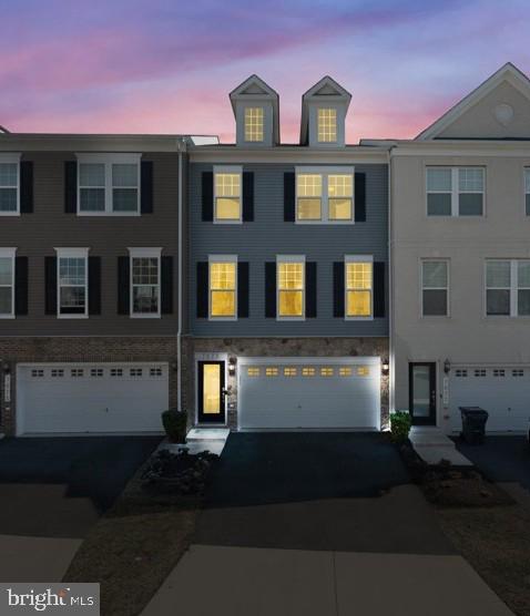 This stunning 3-level townhome, built by Stanley Martin, features a 2-car garage, bonus driveway, deck, and a fenced backyard. With 3 bedrooms, 2 full baths, and 2 half baths, the home boasts numerous unique features. The open floor plan includes a spacious kitchen island perfect for entertaining and a custom-built desk area off the kitchen. The main level offers a large deck with a pergola, patio table and chairs. Beautiful new flooring flows throughout the bright and spacious home. The large primary bedroom includes a walk-in closet, and an en-suite bath with a double sink vanity. The lower-level rec room features walks out to a fenced in yard and fire pit.  This home is conveniently located near major transportation routes, shopping, dining, and entertainment options.