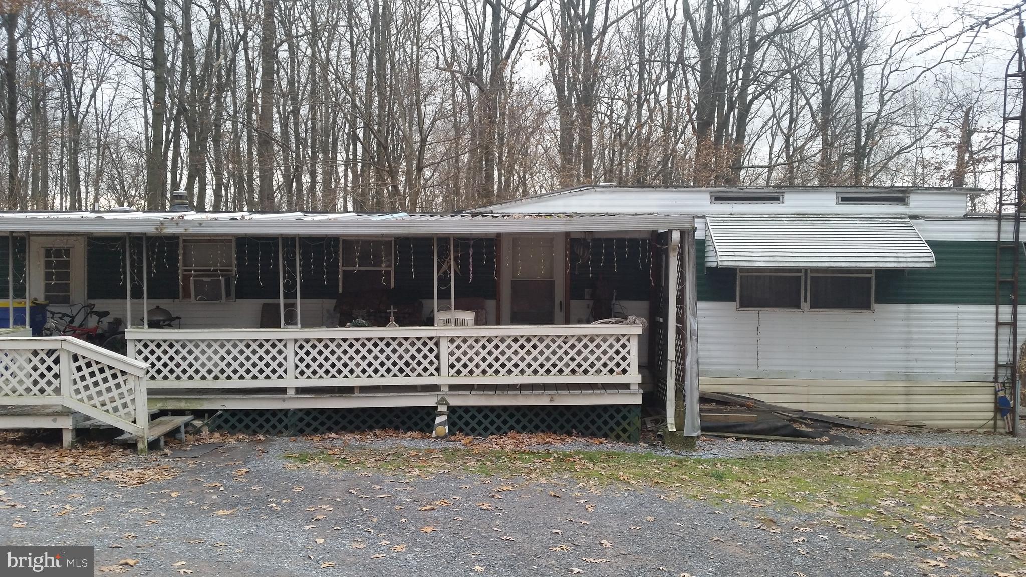 Sold to settle an estate.  1975 mobile home on a foundation.  Driveway on both sides of home.  Large porch.  Home in average condition - with sizeable living room (with a bump out), dining area, 2 bedrooms and full bath.
