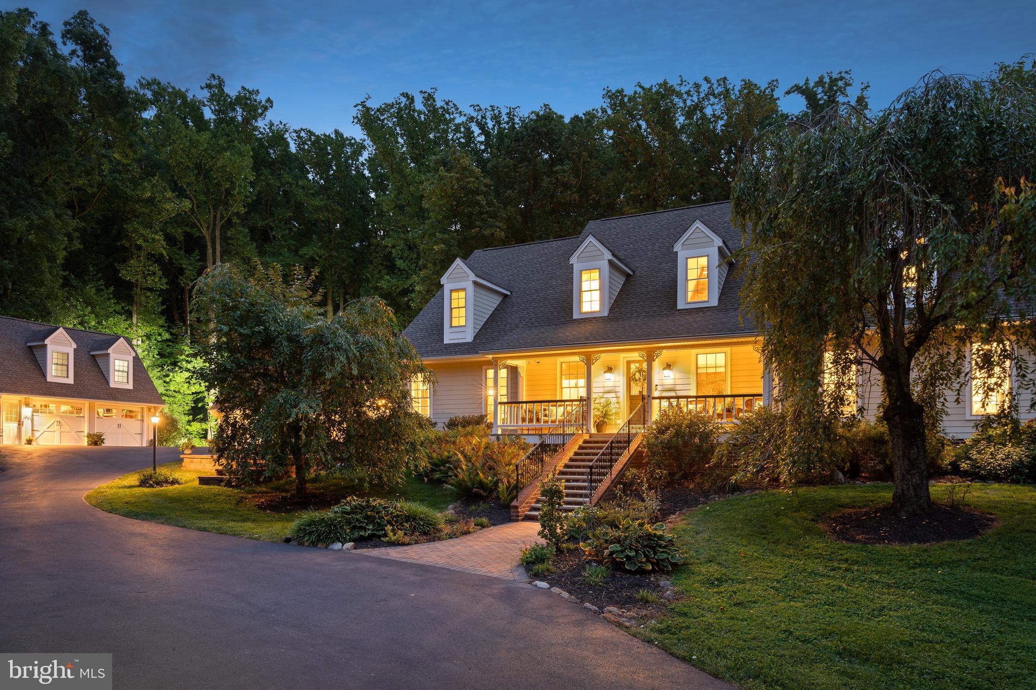 This breathtaking property is nestled in the picturesque rolling hills of desirable Chester Springs. Located at the end of a cul-de-sac, this gated estate features a long winding driveway that transports you to your personal sanctuary! As you arrive, you are greeted by beautifully manicured specimen trees and landscaping, setting the stage for this remarkable custom-built home with 5 bedrooms and 5 and a half baths. The charming front porch offers views of a tranquil pond complete with a springhouse, fountain, and ambient lighting for your enjoyment. Upon entering, a two-story foyer opens into a living room that boasts a vaulted natural wood ceiling, a stone fireplace, and French doors that lead out to the patio, pool area, and surrounding woodlands with walking trails. To the right of the foyer, you'll find a study/office and an opulent primary suite, featuring a propane fireplace, a tray ceiling, recessed lighting, walk-in closets, and an en-suite bathroom complete with double sinks, a soaking tub, and a spacious tiled shower. With its large and numerous windows and 16 oversized skylights, this home is awash in natural light! To the left of the entrance, a step-down dining room features French doors opening to yet another lovely brick patio space. All rooms transition effortlessly into the gourmet kitchen, which boasts high-end appliances, a butler's pantry equipped with a wine fridge and coffee maker, a spacious marble island, a 6-burner Wolf range with griddle, a large two-panel Sub-Zero refrigerator, two dishwashers, double ovens, and much more—ideal for the most discerning chef! This kitchen flows into a family room featuring built-in elements, Italian ceramic stone floors, a stone fireplace, and French doors that lead to the patio and pool area. On the second floor, you will find three additional generously sized bedrooms, one of which has it’s own ensuite bathroom. The lower level includes a fitness area and an additional room suitable for a potential home theater or video gaming room. Numerous luxurious enhancements are present, from radiant heat floors, crown molding and vaulted ceilings to custom built-ins, extensive hardscaping, and outdoor lighting, to name a few. Adjacent to the kitchen and family room, you'll discover a sizable laundry room that connects to a mudroom area and stairs leading to a one-bedroom in-law suite. The attached three-car garage can be accessed directly from the mudroom. For car enthusiasts, there's also an additional detached two-car garage with a finished second floor space. Behind this garage is a storage shed great for outdoor furniture or garden equipment. Your private retreat has a heated saltwater pool with gorgeous stonework and landscaping and a new SportCourt PA pickle ball / multi-sport court! The property consists of over five fully fenced and usable acres, perfect for people and pets to securely roam and explore, with so many incredible spaces for outdoor enjoyment and entertainment. This property has been meticulously maintained and is ready for its next owner to enjoy! Perfect location for the commuter with easy access to the PA Turnpike, Exton, West Chester, Main Line, shopping, dining and much more!!
