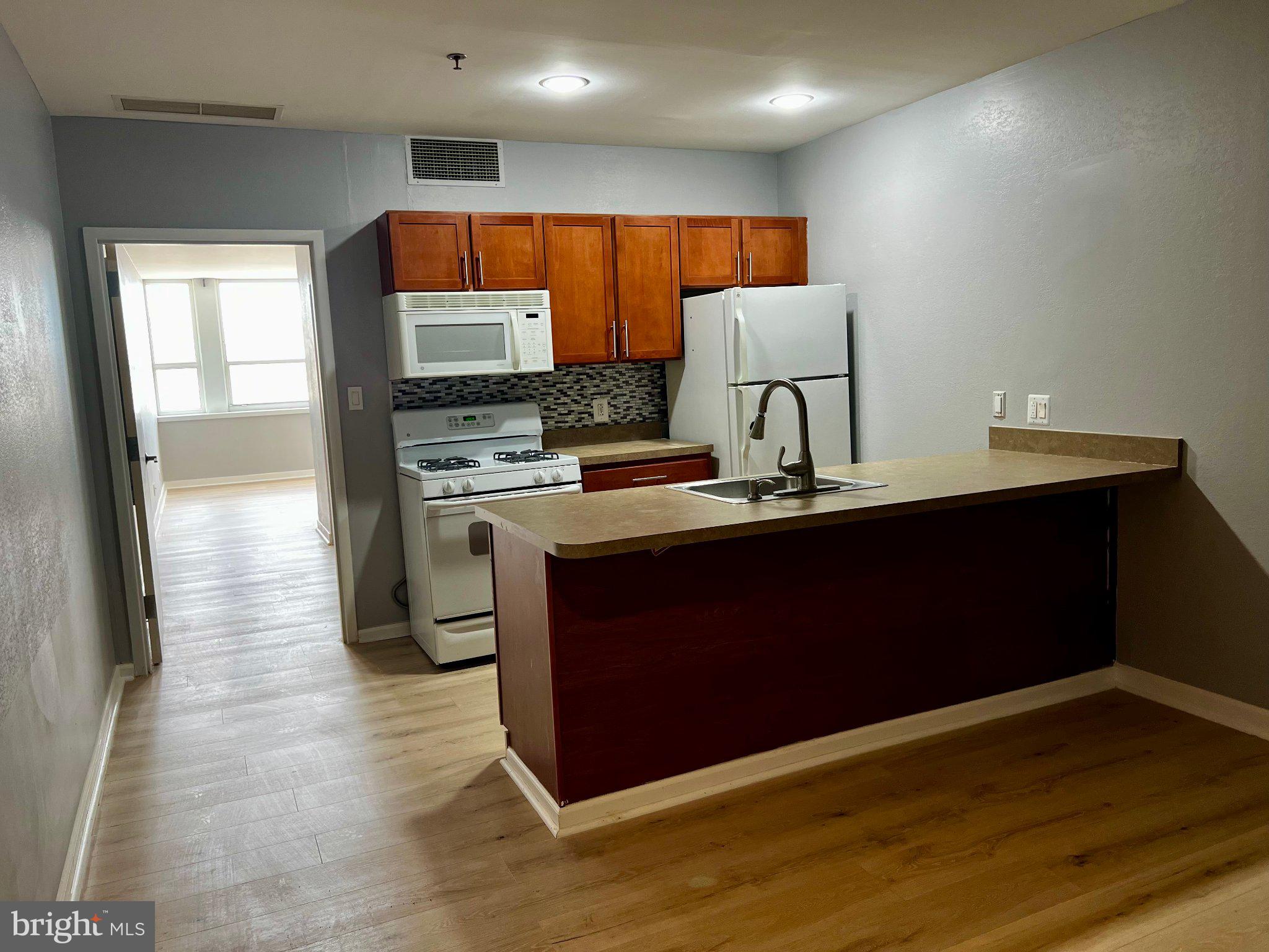 Nestled in the vibrant heart of Chinatown, this newly updated one-bedroom apartment offers a luxurious urban retreat that seamlessly blends comfort with sophistication. This penthouse level unit with a center city skyline view and modern conveniences caters to a discerning lifestyle. Step inside to discover a thoughtfully designed living space that invites relaxation and entertainment. The open layout allows for a warm and inviting atmosphere, with a well-appointed kitchen and ample counter space that is perfect for preparing gourmet meals or hosting intimate gatherings. The spacious bedroom serves as a serene sanctuary, offering a peaceful escape from the bustling city below with unobstructed views of the center city skyline. The updated bathroom features modern fixtures and finishes. Residents of this exclusive community enjoy a wealth of amenities designed to enhance their lifestyle with a fitness center, and multiple community areas for social gatherings and resident hosted events.  The amenity level is currently undergoing planned renovations updating these areas for the residents future enjoyment. The meticulously maintained lobby provides residents with a 24 hour attendant, assuring resident's services and security. Convenience is at your doorstep with easy access to public transportation, including a metro/subway station and commuter rail station, all within a mile. Whether you're commuting to work or exploring the vibrant city, you'll appreciate the effortless connectivity this location provides. Additionally, the proximity to the airport ensures that travel is a breeze. The association fee includes essential services such as air conditioning, electricity, and water, allowing you to focus on enjoying your luxurious lifestyle without the hassle of maintenance. With on-site laundry facilities and a party room for entertaining, every aspect of living here has been thoughtfully considered. Experience the best of city living in this stunning Chinatown residence.