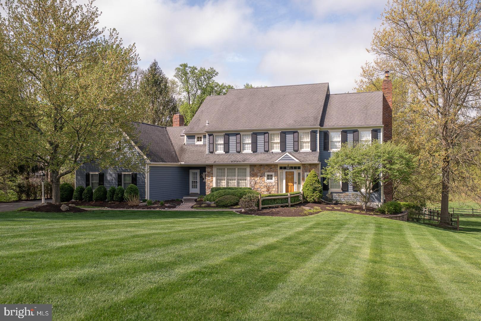 Welcome to 30 Spring Hill Lane in the highly desirable Sunwood Farm neighborhood. This impressive stone-and-siding colonial offers over 4,100 square feet of beautifully maintained living space on a private 1.7-acre cul-de-sac lot. The home features five bedrooms, three full and two half bathrooms, a three-car side-entry garage, and exceptional outdoor living with a large deck, awning, and a saltwater in-ground pool with attached hot tub.  A paver walkway, surrounded by manicured landscaping, leads to the mudroom entry and covered front entrance. Inside, a dramatic two-story foyer showcases a turned oak staircase, along with a coat closet and powder room. The sun-filled office features a wall of windows and custom built-ins, while the formal living room offers a wood-burning fireplace with brick surround and custom mantel. The dining room is ideally located off the kitchen and enhanced by chair rail and crown molding.  The spacious kitchen includes maple cabinetry, granite countertops, tile flooring and backsplash, stainless steel appliances, a center island with seating, and a built-in workstation. The adjacent breakfast room features a triple panel door to the rear deck, while the family room impresses with vaulted ceilings, exposed beams, a Palladian window, and a floor-to-ceiling stone fireplace. A laundry room with garage access completes the main level.  Upstairs, the primary suite offers a vaulted ceiling, dressing area, custom walk-in closet, and a well-appointed bath with dual vanities, soaking tub, skylight, and walk-in shower. Four additional bedrooms, a full hall bath, and an en-suite bath complete this level.  The partially finished walk-out basement provides excellent additional living space, including a recreation room with fireplace, billiards area, bar, half bath, and generous storage.  Additional highlights include hardwood flooring throughout much of the main level, plantation shutters, two new HVAC systems (2024), a whole house generator, and fresh neutral paint. Meticulously maintained by its original owners, this home combines timeless design with modern comfort.  Ideally located in the Phoenixville Area School District, just minutes from shopping, dining, King of Prussia, the Main Line, and the vibrant town of Phoenixville.