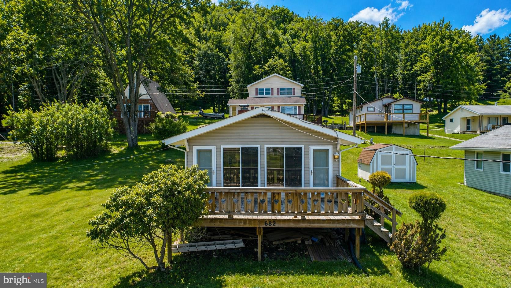 This classic Deep Creek Lake cottage embraces simple life at the lake. Offering 2 bedrooms, 1 full bath and a designated dock slip just across the street, this cottage brings you close to things that matter at the lake at an excellent price. Situated less than a mile from Wisp Resort and just minutes to all  main attractions. This rare opportunity to own one of Deep Creek Lake's original cottages wont last long!