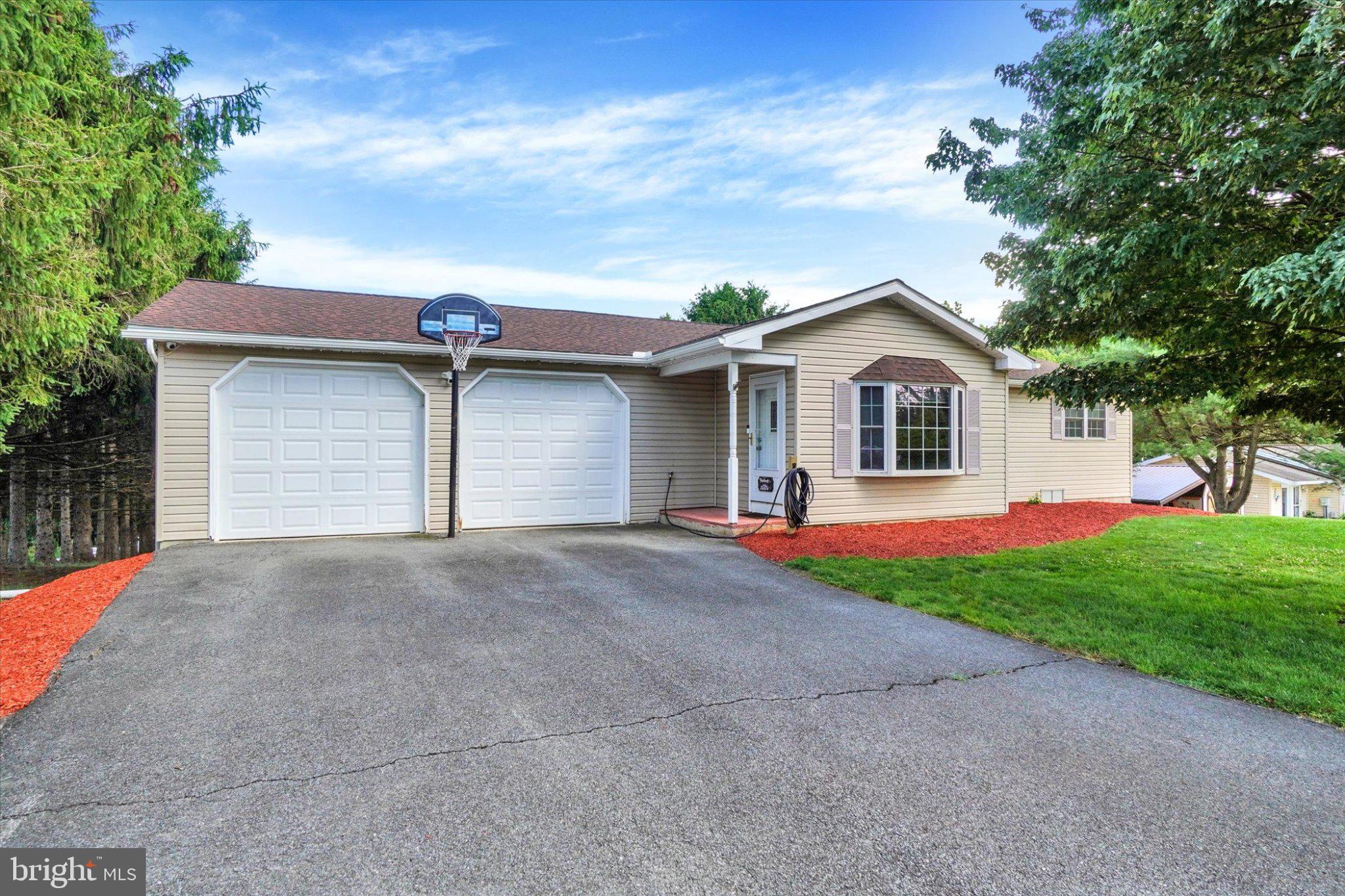 Enjoy the ease of single-floor living in a peaceful setting while remaining conveniently close to local amenities. Lovingly maintained by the same family since it was built, this exceptional home showcases true pride of ownership throughout. Recent updates provide added peace of mind, including a new roof and water heater in 2024, central air conditioning installed in 2020, and an HVAC system that has been professionally serviced annually.  Step outside to a beautiful tiered rear deck overlooking a spacious yard, creating the perfect setting for relaxing, entertaining, or enjoying the outdoors. The finished lower level expands the living space with a full bathroom and wet bar, making it an ideal gathering spot for family and friends. This well-cared-for home offers comfort, functionality, and lasting value in a desirable location.