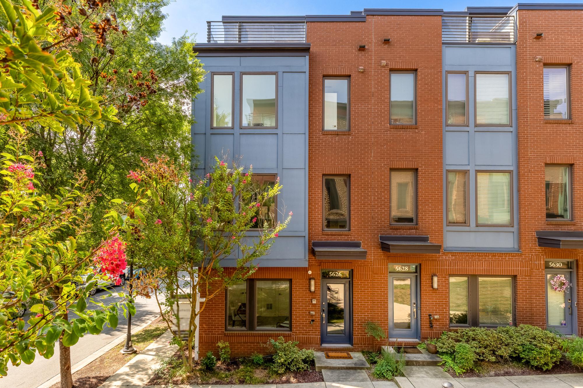 Welcome to 5626 46th Place, a beautifully appointed four-level end-unit townhome in EYA's sought-after Arts District community. Perfectly positioned on a quiet courtyard, this home enjoys a prime location within the community, just steps from the pool, playground, and walking/biking trail. Abundant natural light pours through oversized windows, complementing thoughtfully designed living spaces and numerous upgrades throughout. Offering a rare combination of four finished levels, an attached side-by-side two-car garage, three ensuite bedrooms, two gas fireplaces, and a spectacular rooftop terrace, this home is designed for both comfortable everyday living and effortless entertaining. Thoughtful upgrades include hardwood floors, custom closet systems throughout, new carpet in all bedrooms and the second-level family room, a central vacuum system, and an EV charger in the garage.

The entry level features the attached side-by-side two-car garage with ample storage and a private office overlooking the courtyard. Filled with natural light, this flexible space is ideal for working from home or a fitness room.

The open-concept main level is designed for both everyday living and entertaining. The living room features a gas fireplace and flows seamlessly into the dining area and gourmet kitchen, complete with granite countertops, white cabinetry, stainless steel appliances, a tile backsplash, and a spacious center island. A powder room and rear balcony complete the level. Oversized windows overlooking the courtyard fill the home with abundant natural light.

The upper level features the primary suite with a custom walk-in closet and an ensuite bath with a double vanity and walk-in shower. The second bedroom also includes its own ensuite bath, while the conveniently located side-by-side washer and dryer are situated in the hallway between the bedrooms.

The top level offers exceptional flexibility with a spacious second living room featuring a contemporary gas fireplace, a third bedroom with an ensuite bath, and direct access to the expansive rooftop terrace. A double-sided fireplace creates a seamless connection between the indoor and outdoor living spaces, making the terrace an inviting setting for entertaining, dining al fresco, or simply relaxing while enjoying sweeping neighborhood views.

Residents enjoy outstanding community amenities, including a swimming pool, playground, the Lustine Center with a fitness center, business center, resident lounge, and billiards room - all just steps from your front door.

Located in the heart of the vibrant Arts District, you'll enjoy easy access to Whole Foods, YES! Organic Market, Busboys & Poets, Franklins, Vigilante Coffee, neighborhood breweries, restaurants, and local shops. Outdoor enthusiasts will appreciate the nearby Trolley Trail and surrounding parks for walking, running, and biking. The home is just one-half mile from the Riverdale MARC station and approximately six miles from downtown Washington, DC.