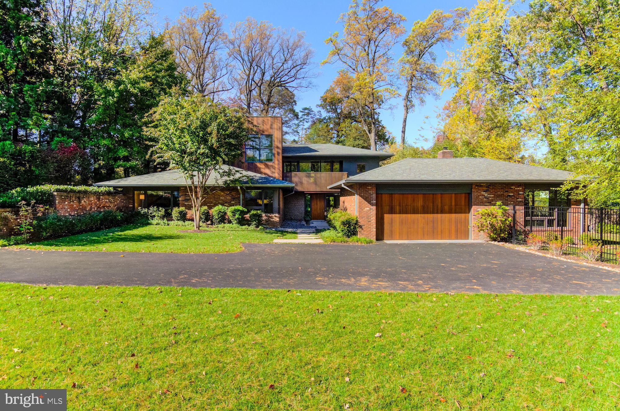 Open Sunday 1/26 2:00 -4 :00 This Mid-Century Modern home embodies to near perfection the three characteristics:  a clean, minimalist aesthetic, an emphasis on bringing the outdoors in and the presence of angular structures. Privately set on 0.70 acres in Country Club Hills this house was renovated from top to bottom with an added second story addition in 2014 by Gruver Cooley and architect Randall Mars. This meticulous renovation welcomes you with a private drive-way lined with a lush garden and beautifully designed and landscaped courtyard leading to a stunning custom built, with pivot hinge, Mahagony front door. With meticulous attention to detail, this home features, to name a few, slate and white oak flooring, all windows custom built by Lepage Millwork, custom millwork throughout by Kendall Jackson of Allegheny Wood Works, kithen design by Lobkovitch Kitchens with Silestone countertops, large granite island and walnut cabinets, heated outdoor pool, Lutron lighting controls, whole house generator .... Main level features a living room overlooking the private back yard, family room with gas fireplace, dining room and gourmet kitchen that opens to a covered porch with built-in natural gas grill by Lynx, first floor master bedroom ensuite, two additional bedrooms and bathrooms and a music/yoga/play room. The second level offers a master bedroom with spa like bathroom and private balcony, two additional bedrooms with jack and jill bathroom and laundry room. This wonderful all brick/hardiplank siding home boasts 5,426 sqaure feet of living on a private lot convenient to DC.