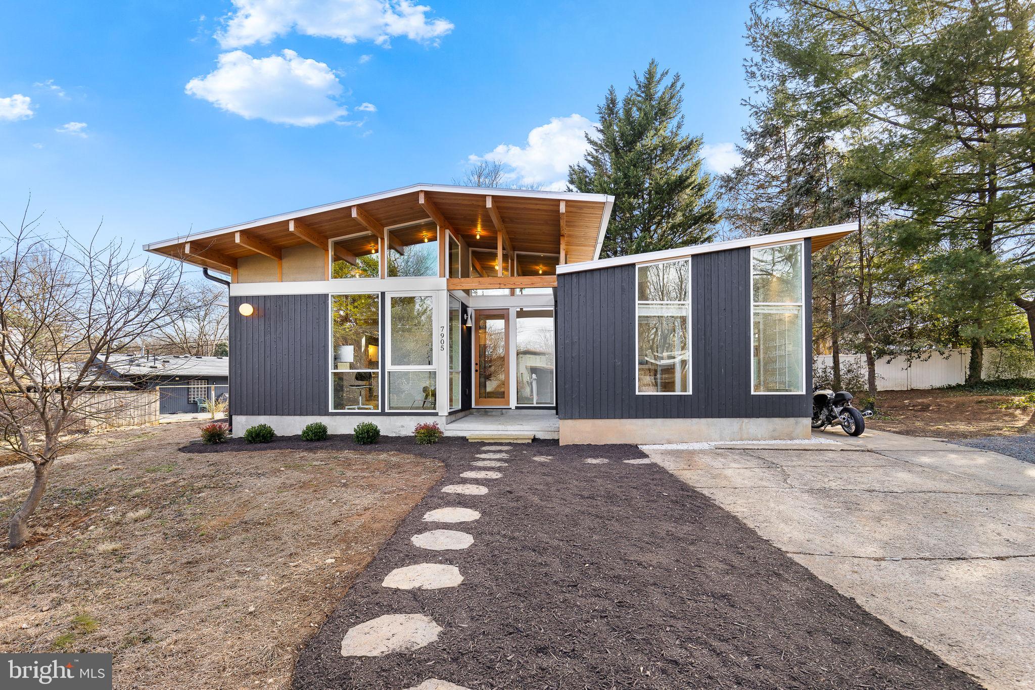 NEW PRICE! - Holmes Run Acres, Stunning Mid-Century Modern Reno! Experience the timeless elegance of this mid-century modern home fully remodeled by Michael Cook Architecture. Nestled on nearly 1/3 acre on a cul-de-sac, this one-level home seamlessly blends sophisticated design with modern functionality. Walls of oversized windows bathe the interior in natural light, blurring the line between indoors and out. New wide plank white oak flooring and Douglas Fir cathedral beamed ceilings span the entire home. The spacious open kitchen features a large center island, Poggenpohl cabinets, handmade Heath Ceramic tiles, premium appliances and built-in seating. The French door in the kitchen opens to private deck. The kitchen flows into the open dining and living room highlighted by the wood burning fireplace. Two ensuite bedrooms boast stunningly designed baths featuring custom ash wood vanities, Dutch Mosa tiles, and Elfa closets offering ample storage. The third bedroom also functions as a versatile family room, with a built-in bar area, an attached half-bath, and a conveniently located laundry space. A dedicated office/den with a built-in desk provides a stylish and functional workspace. Every corner of this home is a showcase of high-end finishes and designer touches. The home is clad in Shou Sugi Ban Japanese cypress siding, and the deck features TimberTech decking.  The slate-style rear patio overlooking the landscaped yard. Conveniently located minutes to INOVA Fairfax, the Mosaic District, and Tysons Corner. Offers easy access to commuter routes (Routes 495, 66, and 50). This home is a true masterpiece, offering mid-century modern charm reimagined for today’s lifestyle.