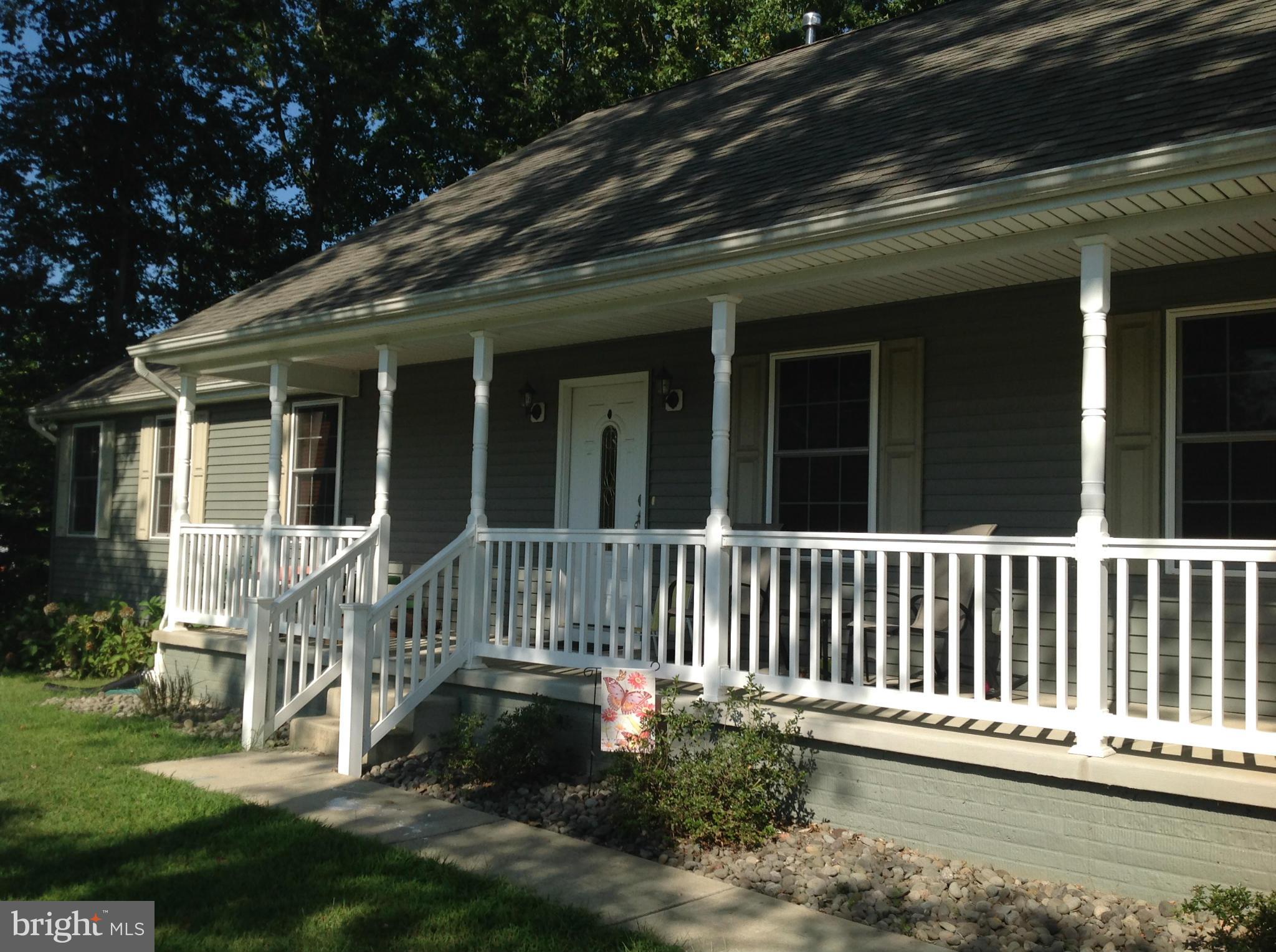 5 year old Rambler backs to trees on 1.4 acres. Open floor plan. Kitchen w cherry/distressed cabinets, island, breakfast bar & beverage center, 5 burner gas stove w double oven.  Bright DR opens into LVR w stone fireplace. Main level MBR w sep. shower/tub, WIC. Walk out, insulated bsmt w space for Rec.Rm, BR, Bathrm & storage.  Front porch. 2 car garage & Fenced yard. No HOA.  Close to Rt 5.