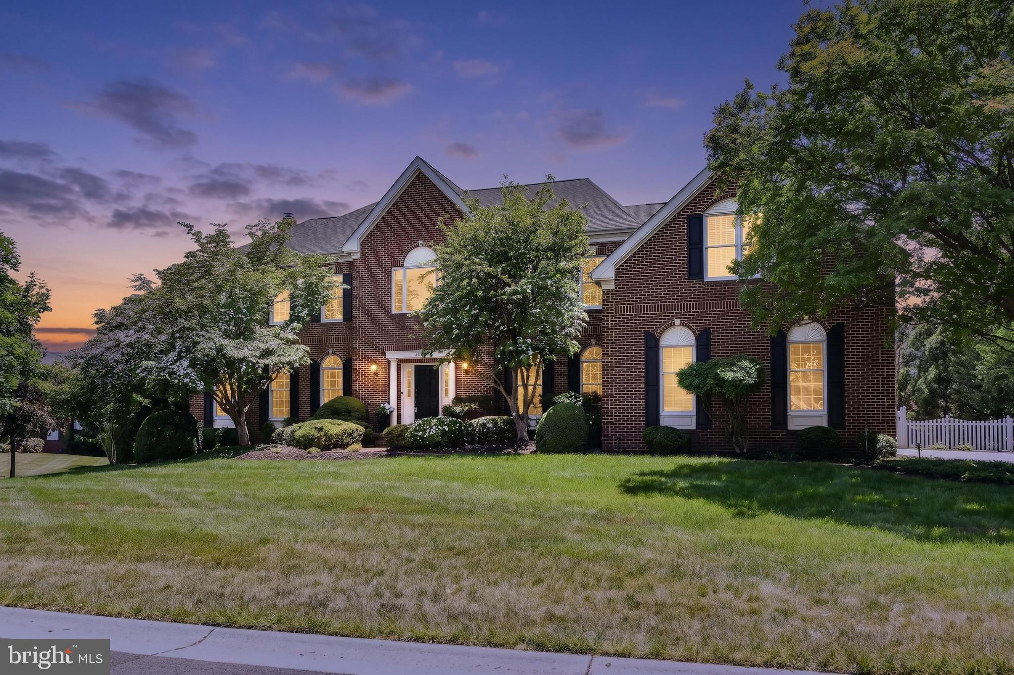 Situated in the prestigious Village of St. Andrews — widely regarded as the premier enclave of estate homes within the gates of  Belmont Country Club  — this exceptional Toll Brothers Master's Series residence commands one of the community’s most coveted settings.
Tucked on a quiet circular street just steps  from the clubhouse, the home is perfectly positioned on a rare, private half-acre lot with only one neighboring property, creating an uncommon sense of space, exclusivity, and retreat within the heart of the community. Mature tree screening enhances the sense of privacy while preserving a bright, open atmosphere filled with incredible morning light throughout the rear of the home and grounds.
With nearly 7,000 square feet of refined living space, this stately three-sides brick estate has been extensively upgraded with a level of quality and design curated for luxury living and elevated entertaining.
Inside, an elegant two-story foyer introduces grand-scale rooms, newly refinished hardwood floors, fresh designer paint, abundant natural light, and sophisticated Restoration Hardware lighting that create a timeless yet modern aesthetic throughout.
The gourmet chef’s kitchen is the heart of the home, appointed with premium Thermador appliances including a 6-burner range with griddle, dual dishwashers, warming drawer, steamer, pot filler, custom cabinetry, and illuminated accent details — all flowing seamlessly into an expansive family room anchored by a dramatic stone fireplace.
The upper level offers five spacious bedrooms and three beautifully updated baths, including a luxurious owner’s retreat featuring a private sitting room with fireplace, expansive custom closets, and a spa-inspired bath with steam shower and soaking tub.
Designed for exceptional entertaining, the fully finished lower level features a custom bar with integrated appliances including a wine refrigerator, microwave, warming drawers. The basement is complete with large recreation spaces, a stone fireplace, fitness area, bonus rooms, wine cellar and a full bath.
The stairs lead outside to a private resort-like backyard. Extensive hardscaping, curated landscaping, mature plantings, integrated outdoor audio, and over $30,000 in architectural and landscape lighting create an extraordinary evening ambiance throughout the grounds. Thoughtfully designed perennial gardens and herb plantings provide color, texture, and blooms throughout the warmer months.
The fully fenced backyard offers a rare combination of privacy, flat usable space, and future flexibility — including ample room to build a pool while still preserving expansive recreation and entertaining areas, a feature seldom found within Belmont.
A fully customizable Trimlight permanent exterior lighting system elegantly outlines the residence, allowing effortless seasonal and holiday illumination without ladders or temporary installations.
Additional luxury features include:
✔ Whole-home generator
✔Insulated and sealed attic for energy efficiency
✔ Smart home integration with security and exterior cameras
✔ Sonos multi-room audio system with outdoor speakers
✔ 3-car side-load garage with EV charging
✔ Dual laundry rooms
✔ Irrigation system
✔ Skylights and expansive windows throughout
Residents of Belmont Country Club may enjoy an unmatched gated lifestyle with championship golf, resort-style pools, tennis, dining, fitness, walking trails, and a vibrant social club atmosphere — all with HOA services that include lawn maintenance, internet, cable, and trash service.