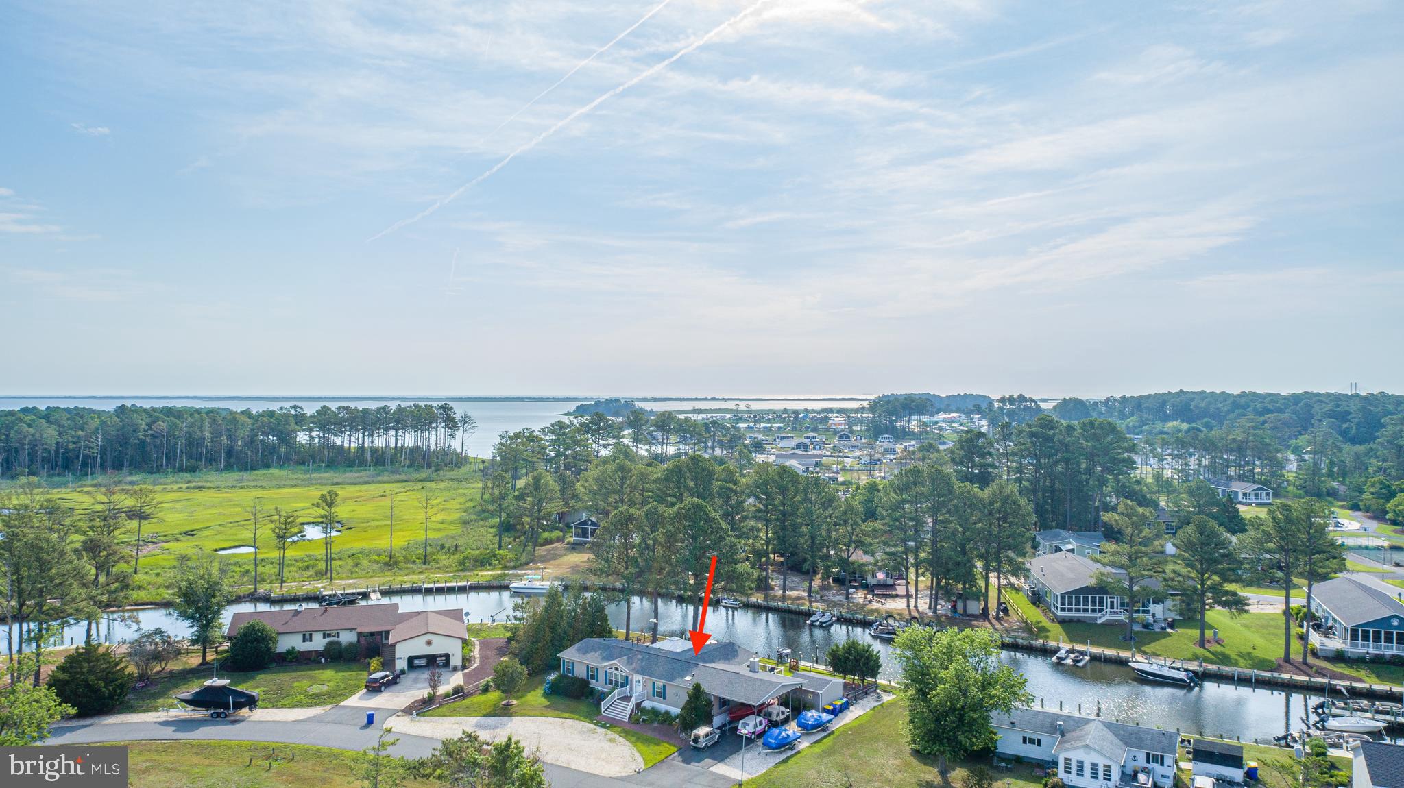 Located in peaceful Pot-Nets Coveside, this waterfront home offers the coastal lifestyle buyers dream about. With approximately 118 feet of bulkhead waterfrontage, there is plenty of room for your boat, jet skis, and all your water toys right outside your back door. Relax on the waterfront patios, enjoy the expansive decking, or unwind in the screen house located on the deck while taking in peaceful water views. An outdoor shower adds convenience after a day on the water, making it easy to rinse off before settling in for the evening.

Built in 2008 and offering approximately 2,200 square feet of living space, this home features 3 bedrooms, 2.5 bathrooms, and multiple living areas, including a bright sunroom, front living room, and cozy fireplace living room. Beautiful wood and LVP flooring flow throughout the home, while upgraded quartzite countertops in the kitchen and bathrooms add both style and function.

Outside, thoughtful details continue with soaker hose systems for the potted plants on the deck and landscaped beds, helping everything stay beautiful with ease. A carport and shed provide extra storage, while the asphalt driveway and additional rock parking area offer abundant space for guests, boats, trailers, or off-season parking. A new roof installed in 2025 adds peace of mind. As an added bonus, the screen house and select outdoor and indoor furniture are available for purchase separately, offering buyers an opportunity to enjoy this outdoor and indoor oasis exactly as it is.

If you have been searching for spacious waterfront living with incredible outdoor spaces, room for all your toys, and the relaxed coastal lifestyle Pot-Nets Coveside is known for, this home is a must-see. Schedule your private showing today!
