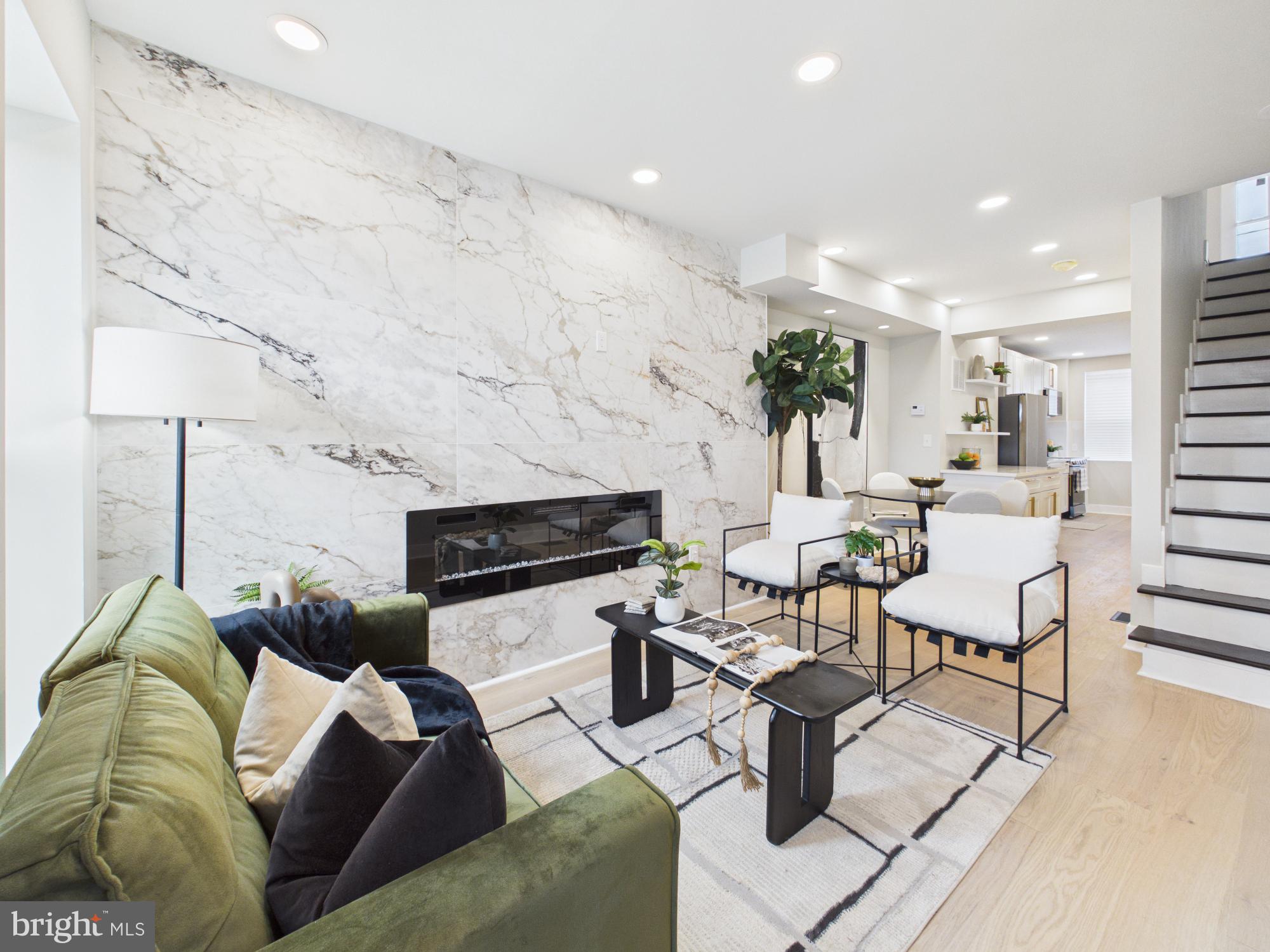 Welcome to Baltimore City Luxury Living! Located in the highly sought after Baltimore Pumphouse corridor, this fully developed block features a newly renovated Fitness Gym across the street and a newly built organic Food Hub adjacent to the house! With over $27 million designated for the Baltimore Pumphouse, the transformation is geared for Baltimore’s creative community to gather, dine, and explore. With instant equity and custom living on every floor - this gem is a MUST SEE! As you enter, you’re greeted in the living area by an expansive floor to ceiling ceramic tiled fireplace wall. The gourmet kitchen features stainless steel appliances, upgraded quartz countertops and a custom LED screened faucet that shows the temperature of the water and keeps track of how long it’s been running! Complete with a half bath, and designated dining room with GIMBAL lighting, this main level is truly captivating. The second floor hosts 2 generous sized bedrooms. The primary suite features a one of a kind tile slat fireplace, custom ceiling fan, walk in closet with an organizer and an oversized shower with 10ft floor to ceiling surround tile! The fully finished basement has an additional bedroom with a custom wood fireplace and a full bath! 15 Year Roof Warranty and 1 Year Home and Sewer Warranty! Schedule your private showing TODAY!