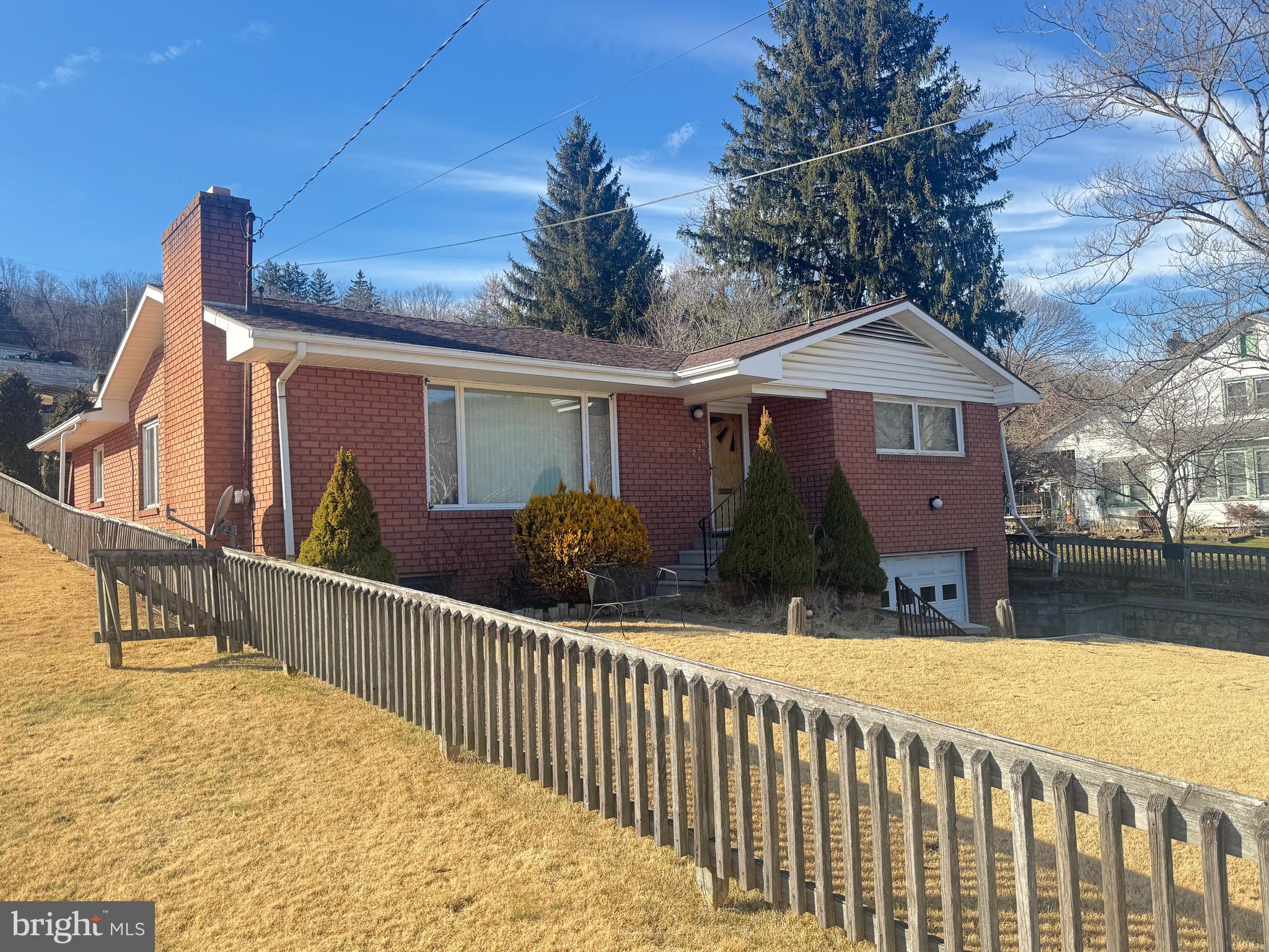 MAINTENANCE-FREE TOTAL BRICK RAISED RANCHER HOME.  EXTERIOR OFFERS 35 YEAR ARCHITECHUAL SHINGLE ROOF, SMALL 4’ X 4’ COVERED PORCH/STOOP, CONCRETE WALKWAY, STEPS OFF WALKWAY LEADING TO UNDER HOUSE GARAGE WITH 1½-CAR METAL GARAGE DOOR, PAVED DRIVEWAY, STONE WALL, METAL FACIA, VINYL SOFFITT GABLES, BARN STYLE OUT-BUILDING AND LARGE FENCED FRONT AND REAR BACK YARDS (ZOIZAH GRASS).    INTERIOR INCLUDES LIVING ROOM W STONE/BRICK FIREPLACE & CARPETING.  DINING ROOM W NEW LIGHT AND CARPETING, KITCHEN WITH STAINLESS STEEL APPLIANCES, MASTER BEDROOM WITH (2) CLOSETS, GUEST BEDROOM W 6’ X 7’ WALK-IN CLOSETS, FLORIDA/SUN ROOM W HOT TUB! SKYLIGHTS, GLASS FRENCH DOOR AND CERAMIC TILE FLOOR. LOWER FLOORS CONTAINS LARGE FAMILY ROOM, UTILITY ROOM AND LAUNDRY ROOM W WASHER & DRYER INCLUDED.  OTHER AMENITIES:  CEILING FAN/LIGHT, NEWER WOOD CASEMENT DOUBLE-PANE WINDOWS (TILT-OUT), (2) LOTS = OVER 1/3 ACRE.  PROPERTY SOLD IN “AS IS” CONDITION.  CALL TODAY FOR VIEWING….YOU WON’T REGRET!!!