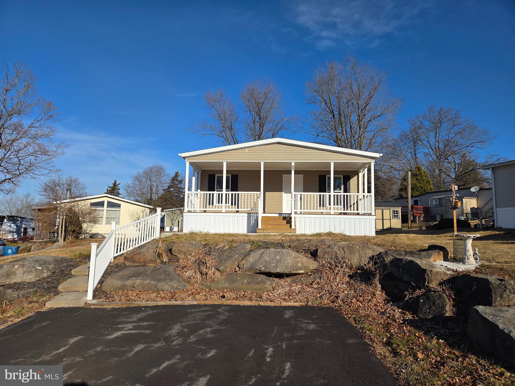 Come see this beautiful 3 bed 2 bath home with a large covered front porch.  As you walk through the front door you will be greeted by a large living room and an eat in kitchen with island, ample cabinet and countertop space, and a walk-in pantry.  The master has a nice sized closet and a full bath with a shower.  Down the hall you will find two other bedrooms, a full bath and laundry room.  Outside there is a 2 car driveway, storage shed and 1 year warranty.  The $ 991 monthly land lease includes 1500 gallons of water/sewer use, the pool, mini golf, chip and putt, fishing ponds and use of the community pool for private functions. Park approval required