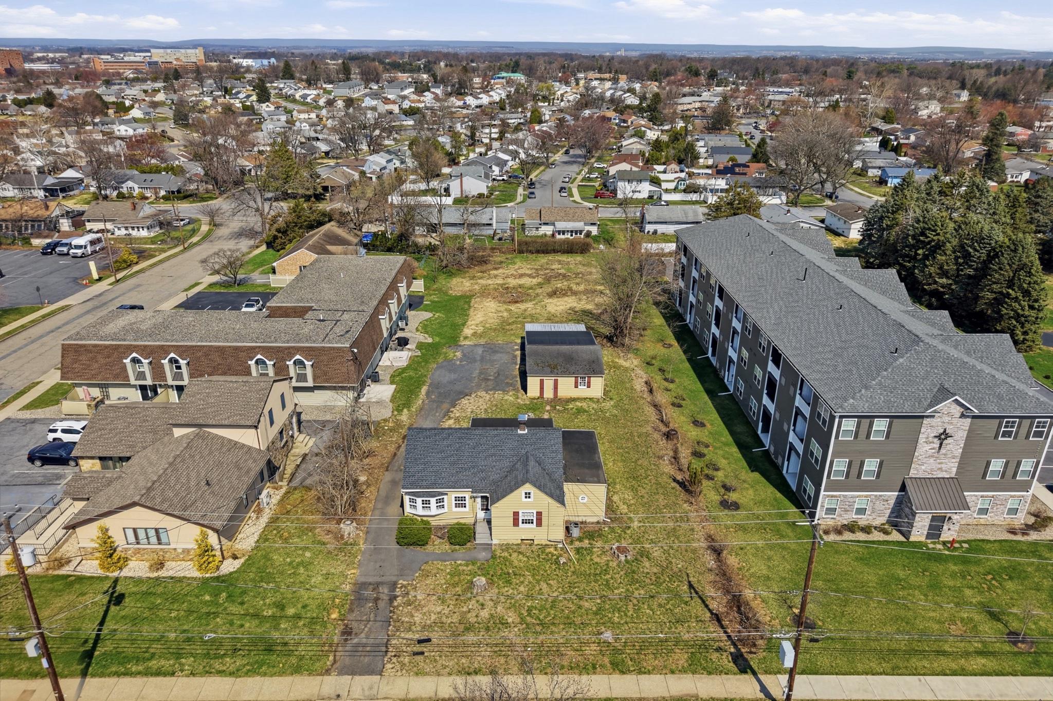Fully approved for a 6-dwelling configuration, this offering includes an existing, income-producing Cape Cod residence along with approvals in place for 5 new-construction townhomes. Plans and Elevations available on request.
The townhome development consists of 1 triplex and 1 duplex, thoughtfully designed with driveway access, front parking, and pedestrian walkways leading to the rear of each home—an efficient and attractive layout for future residents.
The existing detached Cape Cod features 3 bedrooms and 2 full baths and presents immediate rental upside. Most recently leased in 2026 for $2,600/month, the home is currently vacant and ready for occupancy or repositioning. Additionally, two of the three garage bays are leased on a month-to-month basis, generating $350/month in supplemental income.
Ideally situated in a highly accessible location, the property is within walking distance to major employers including Jefferson Health Network and St. Luke’s University Health Network facilities. Residents will also benefit from close proximity to highway access and the area’s charming Historic District, offering dining, shopping, and lifestyle amenities just minutes away.