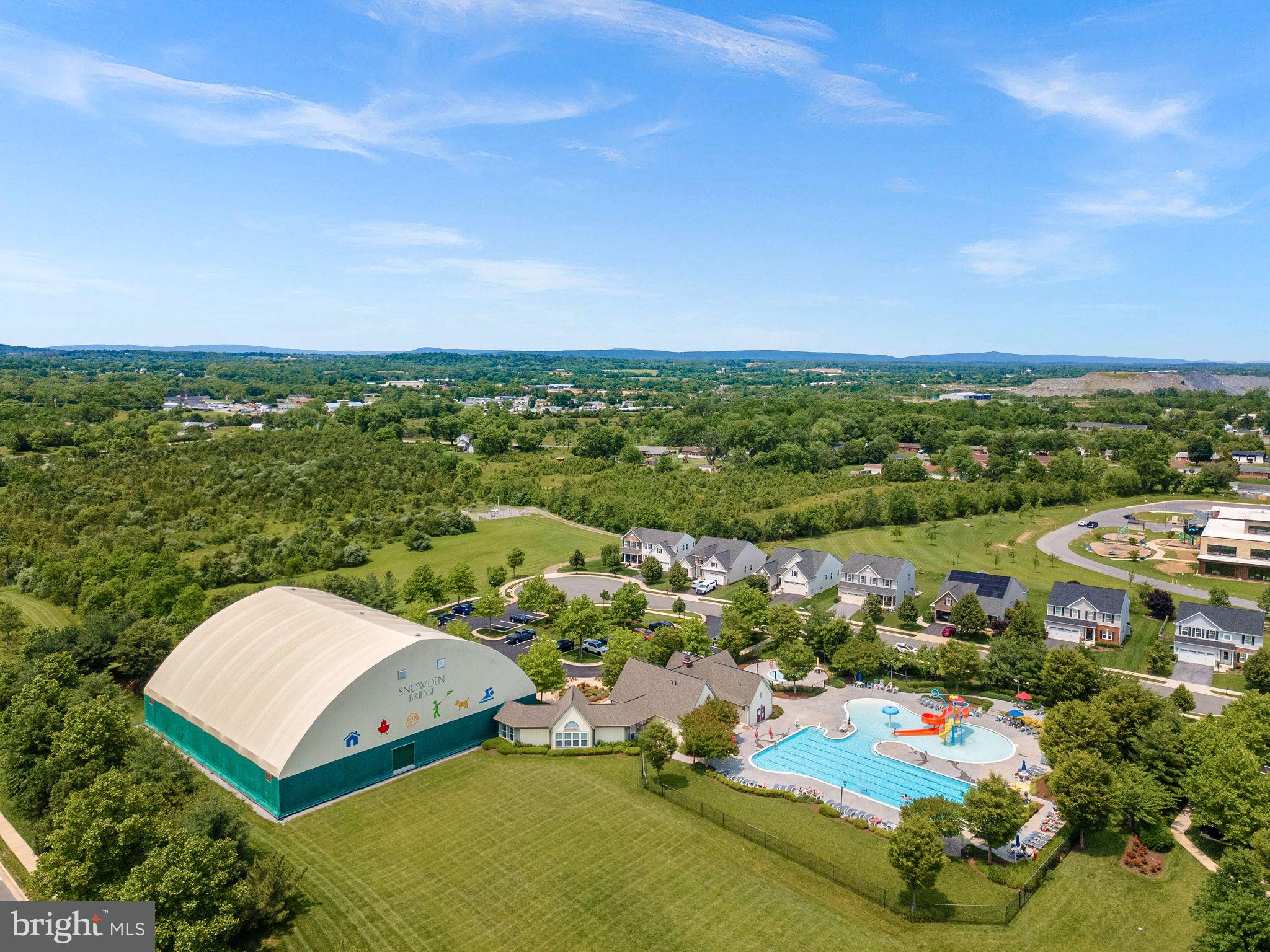 End-unit townhome with exceptional community amenities, nestled just outside of the Blue Ridge Mountains! Luxury vinyl plank flooring flows throughout all three levels. The gourmet kitchen is the heart of the home, featuring white Corian countertops, an oversized island with ample seating, gas cooking, a deep sink, stainless steel appliances, a pantry, and a separate breakfast area with mountain views. The open layout flows seamlessly into a sun-filled family room with large windows and a ceiling fan. Upstairs, the spacious primary suite features a walk-in closet and a spa-like en suite bath with a soaking tub, separate shower, and dual sinks. Two additional bedrooms, a full hall bath, and convenient upper-level laundry complete the bedroom level. The walk-out lower level offers a versatile recreation space, with a half bath, closet, and storage. The home also includes a one-car garage with opener, and EV Charger. Located in an amenity-rich community offering a 15,000 sq. ft. indoor sportsplex, private splash park, bike track, swimming pool, picnic pavilion, trails, dog park, on-site elementary school, and day care center. With its captivating views, convenient location, and hometown feel, Stephenson is the perfect place to call home. Enjoy a variety of outdoor activities nearby, including scenic hiking trails in Shenandoah National Park and picturesque drives along Skyline Drive. Situated just minutes from major commuter routes, shopping centers, and Downtown Winchester, this area offers the perfect blend of convenience and tranquility. Explore local restaurants, historic landmarks, and unique shops in Downtown Winchester, with easy access to I-66 and I-81 for commuting toward Northern Virginia and Washington, D.C. A wonderful home with space, comfort, and lifestyle amenities all in one!