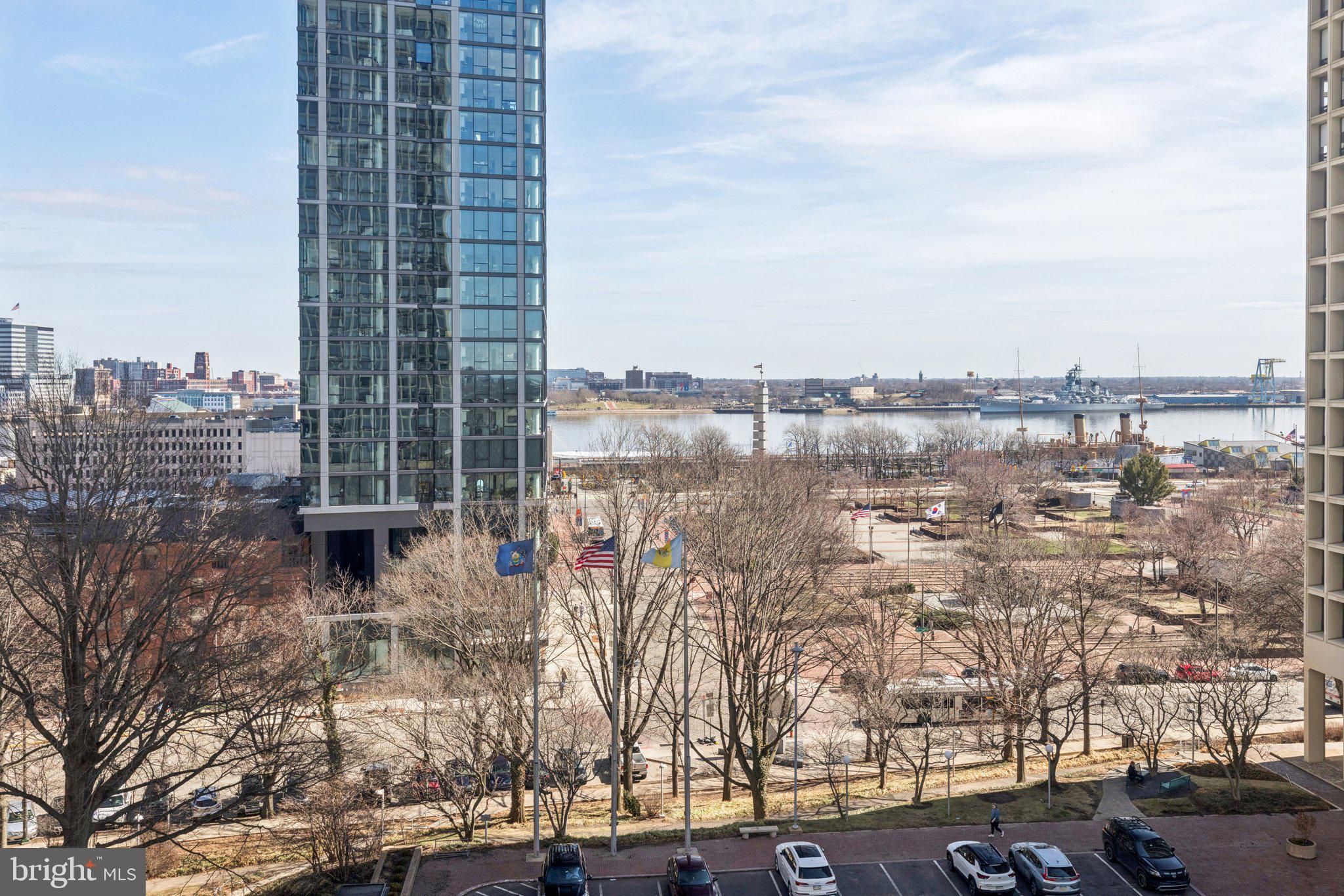 Updated corner two bedroom with spectacular sunrise views over the Delaware River at Society Hill Towers! This spacious home features incredible natural light from floor-to-ceiling windows in all rooms, updated kitchen and bathroom, generously sized bedrooms, and excellent closet/storage space throughout. Enter through the welcoming foyer with coat closet into the open great room featuring see-forever city views to the north, river views to the east, and ample space for living, dining, and entertaining. Adjacent is the galley-style kitchen with wood cabinetry, granite countertops, stainless steel sink with disposal, tile floor, breakfast bar, and a full suite of stainless steel appliances. The spacious primary suite boasts views of the waterfront and a large walk-in closet. The second bedroom is generously sized and has more waterfront views, a ceiling fan, and wall of closets. Both bedrooms enjoy use of an updated hall bathroom with modern white vanity, tub shower with white subway tilework, modern gray tile floor, and recessed lighting. There are parquet wood floors and additional closet space throughout the home.
Residents of Society Hill Towers enjoy a 24-hour doorman and all utilities plus basic cable. Access to the building's outdoor seasonal pool, fitness room, storage lockers, and parking in the building's underground garage are available for an additional fee. Also, there is an on-site Philly Car Share, a coin operated laundry room in the basement, and a shopping plaza on site with a market, dry cleaner, and one of Philly's most acclaimed restaurants, Zahav.