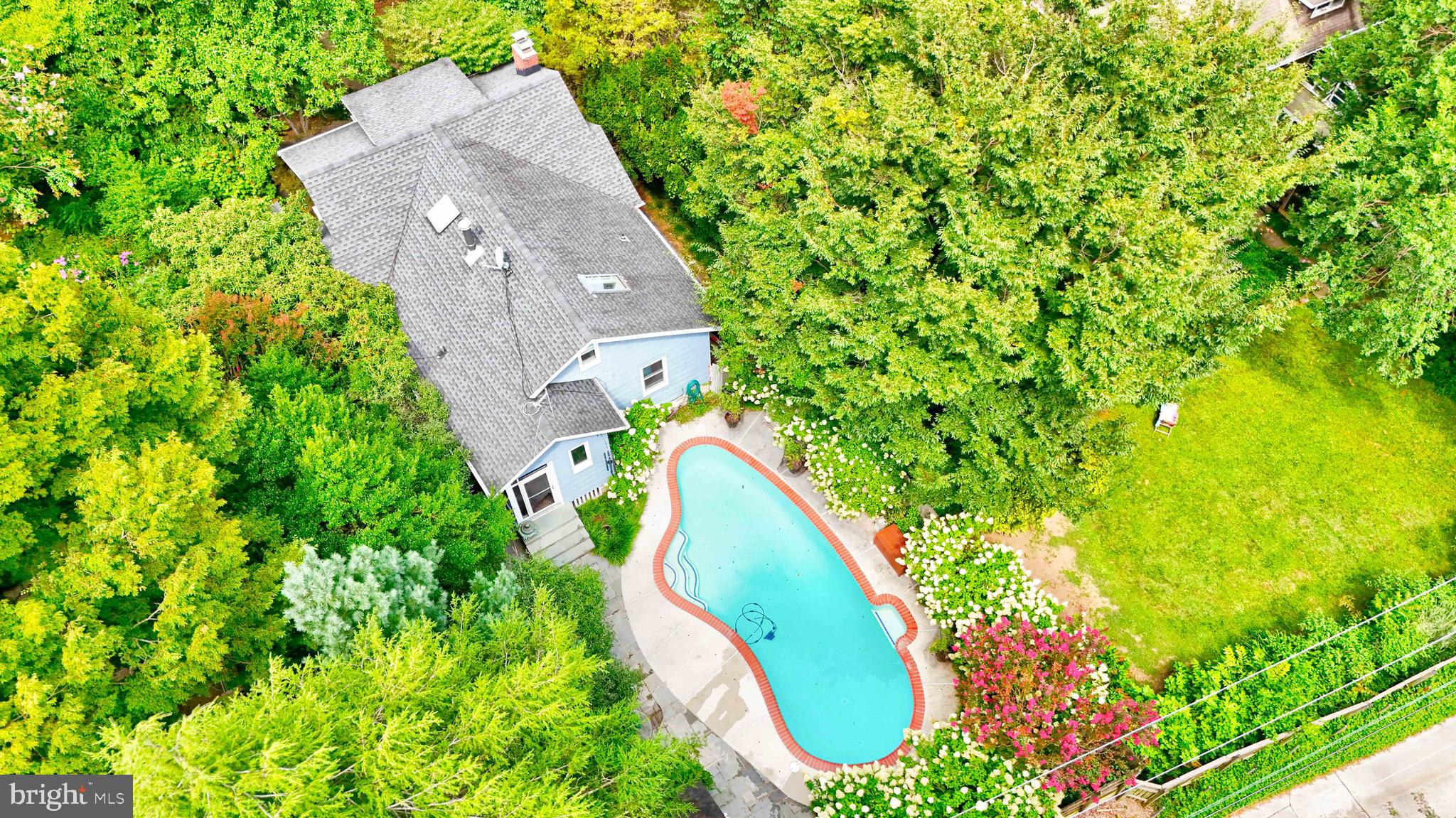 OPEN HOUSE SATURDAY, APRIL 18, 2026 1:00 PM-2:30 PM**SWIMMING POOL PARADISE IN MT WASHINGTON***Pool is now open for the season***Surrounded by a sea of blooming white hydrangeas, this quintessential Mt Washington gem sits on a picturesque, winding, tree  lined street.  Step through a charming wooden picket fence and you'll be greeted by lush perennial gardens featuring pachysandra, hostas, Japanese maples, crape myrtles, oak leaf hydrandeas, fig tree, helleborus, river birch, and more.  A welcoming covered front porch, anchored by two custom benches, invites you inside.  The formal living room boasts built-in bookcases, and a charming built-in bench.  The spacious formal dining room is lined with custom cabinetry, while the stainless-steel kitchen is a cook's delight complete with abundant storage, a built-in banquette and thoughtful built-ins throughout.  Two entry level bedrooms share a full bath, while the private second floor hosts a third bedroom with built-in bookcases and a wood burning stove.  The finished lower level offers a powder room, utility room, brand new water heater,  generous storage and a walk-out to the back yard oasis.  Out back, the fully fenced and private yard features the show stopping Anthony in-ground pool with slate patio, all surrounded by vibrant hydrangeas.  Two Storage sheds and an outdoor storage box add convenience.  Being sold "as is", with inspections welcome for informational purposes only. -just a truly special home ready for its next chapter.  Contract fell apart**back on the market