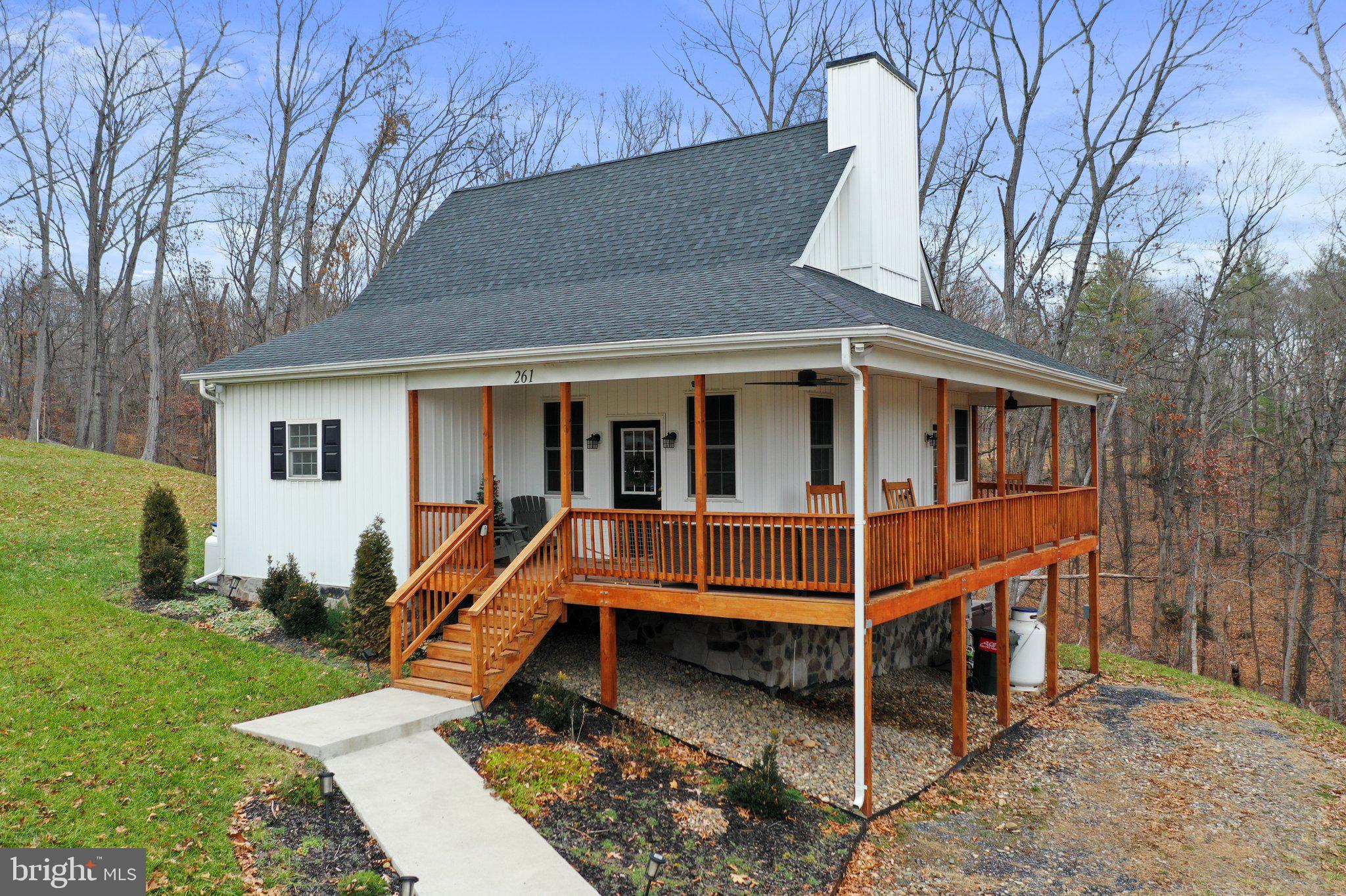 Charming 3-bedroom, 3.5-bathroom cottage located near the Shenandoah National Park & just outside of downtown Front Royal.  Escape the hustle and bustle of everyday life and immerse yourself in the breathtaking mountain views surrounding this cozy home. The home offers an open-concept living area and is designed for relaxation and socializing, with a cozy stone fireplace, spacious dining area, and a fully equipped kitchen that allows for easy meal preparation, complete with modern appliances and ample counter space. The main level features a primary bedroom and ensuite with 2 additional well-appointed bedrooms with full private baths that offer comfortable accommodations for family members or guests. The fully finished walk-out basement adds further living space, including a family room,  powder room, primary bedroom with full bath and walk-in closet, laundry room, and a nice patio area. Step outside on the private wrap-around deck where you can soak in the breathtaking views of the mountains and Skyline Drive and enjoy your morning coffee in this tranquil setting, making it an ideal spot for relaxation and rejuvenation or a perfect entertaining area. Stay connected with High-speed internet, and explore local attractions, including wineries, historical sites, and charming downtown Front Royal. The home is situated in a community that offers exclusive access to the Shenandoah River and includes swimming, fishing, kayaking, and a wide range of outdoor activities. It is easily accessible from I-66 and other major routes.
The home is currently used as an Airbnb-Financials are available upon request.  All sizes are approximate.