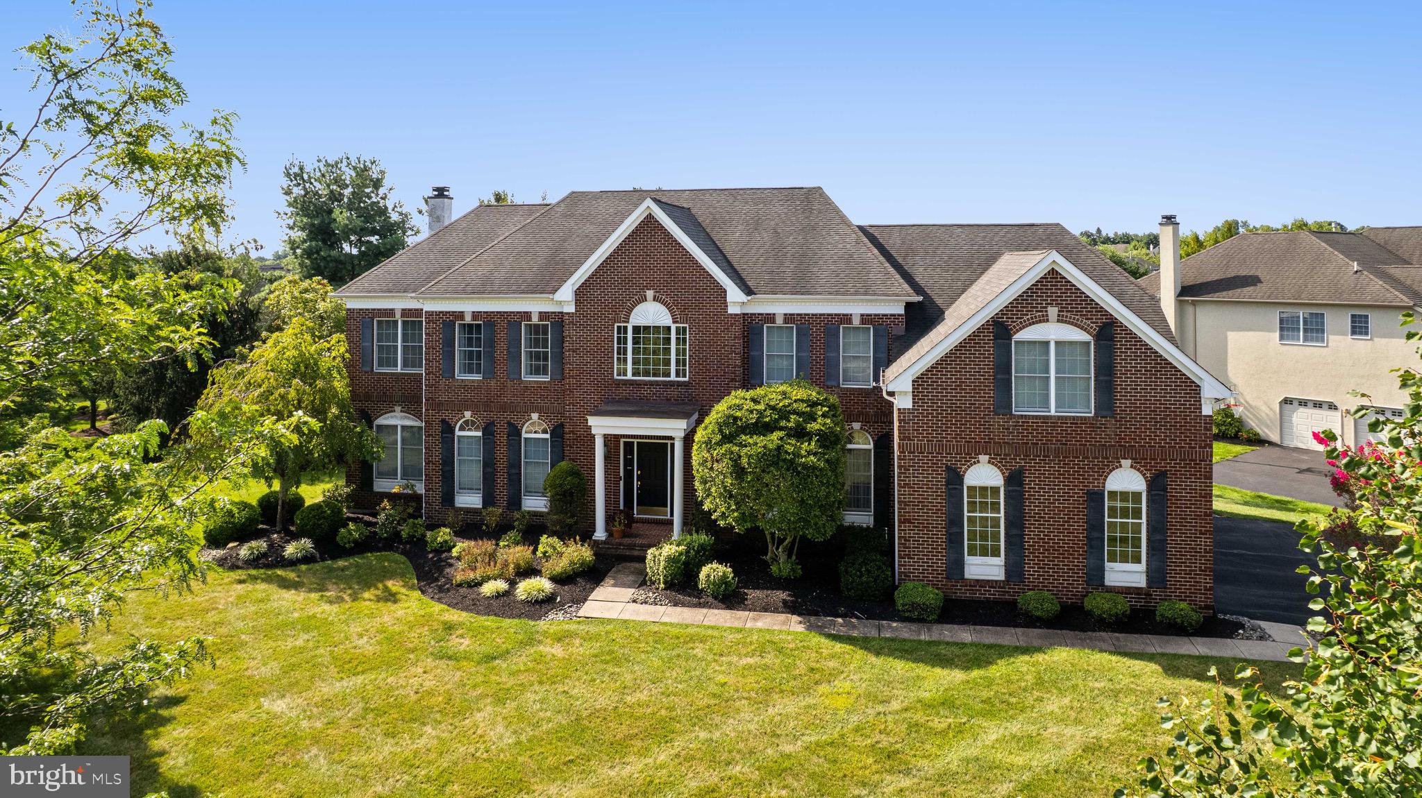 Welcome to this elegant residence in the sought after Northampton Hunt community, set within the top rated Council Rock School District. Perfectly positioned on a corner lot, the home features a stately brick facade and professionally landscaped grounds that create a lasting first impression. The private backyard offers a beautiful paver patio, ideal for outdoor dining and entertaining.

Step through the front door into a grand two story foyer showcasing a graceful turned staircase, gleaming hardwood floors, and detailed moldings that flow throughout the first floor. The foyer is flanked by formal living and dining rooms, both designed for comfortable gatherings and special occasions.

The spacious eat in kitchen is the heart of the home, featuring a two story breakfast area with abundant natural light, an island with granite countertops and seating, rich wood cabinetry, and stainless steel appliances including double wall ovens. A second staircase provides easy access to the upper level, and sliding doors open directly to the backyard patio for seamless indoor outdoor living.

Adjacent to the kitchen, the inviting family room features a striking stone fireplace and plenty of space to unwind. A private office offers the perfect setting for working from home. A powder room and laundry room complete the main floor.

Upstairs, the serene primary suite offers crown molding, a cozy sitting area, and a luxurious bath complete with a Jacuzzi tub, double vanity, stall shower, and private water closet. Three additional bedrooms and two full bathrooms provide ample comfort for family and guests.

A spacious three car garage adds to the home’s appeal, offering convenience and storage. Blending timeless design with everyday functionality, this home is the perfect balance of elegance, comfort, and location.