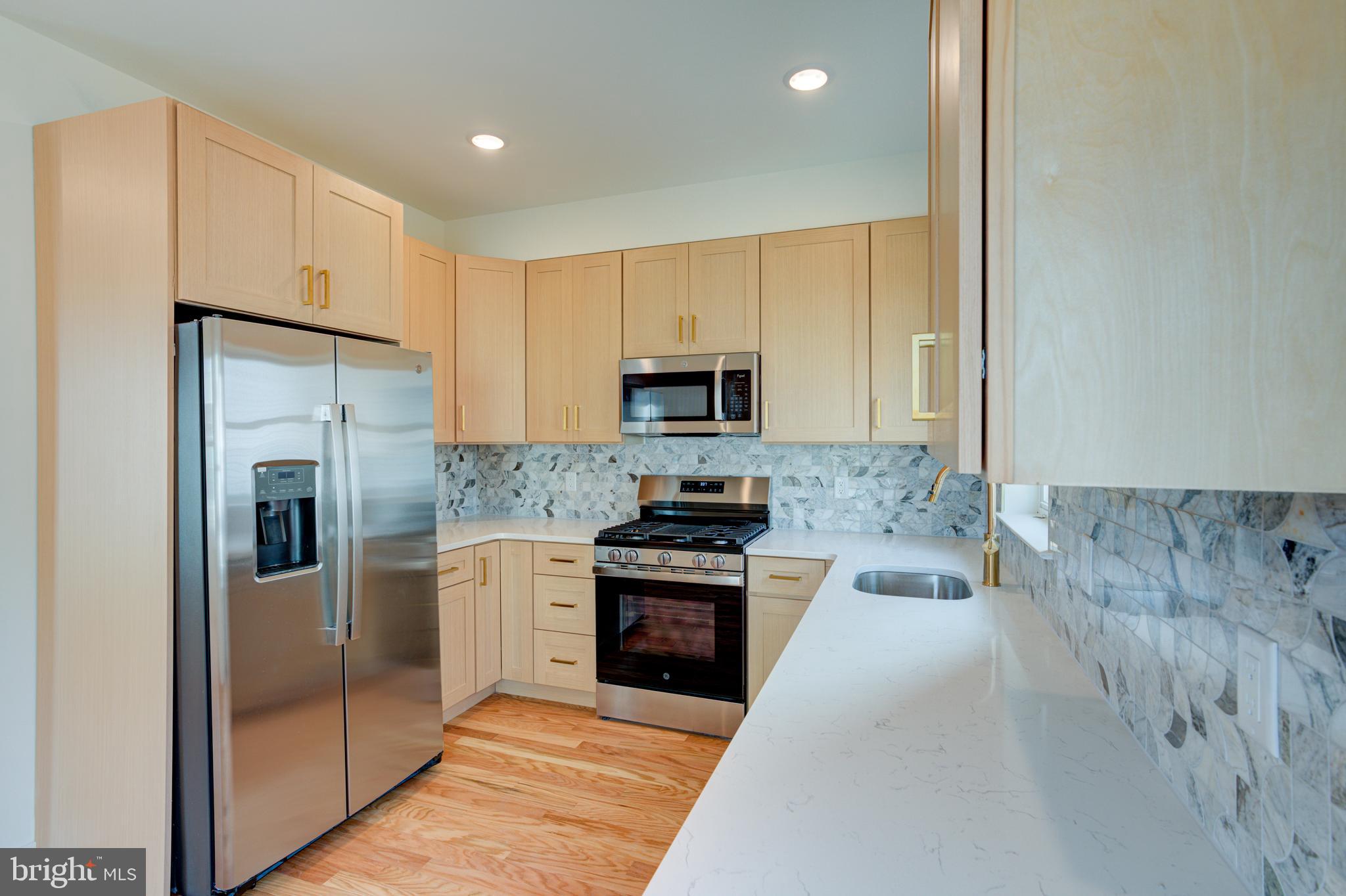 Welcome to this stunning new construction home in the heart of East Kensington, one of Philadelphia’s most vibrant and rapidly growing neighborhoods.  This home is a corner row so enjoy all the extra natural light from the wall of  extra windows  .Built by a well-known local developer, this thoughtfully designed 3-story home with a finished basement offers modern finishes, flexible living space, and a 10-year tax abatement plus a 1-year builder warranty. Step inside to an open and inviting main level featuring hardwood flooring throughout, a spacious living room, dining area, and a beautifully designed kitchen. The kitchen showcases quartz countertops, stainless steel appliances, stylish backsplash, and modern cabinetry, making it perfect for both everyday living and entertaining. Just off the kitchen is a nice-sized private backyard, ideal for relaxing, gardening, or hosting gatherings. The finished basement adds valuable living space and includes a bedroom, full bathroom, and flexible area that could be used as a home office, gym, media room, or guest space. On the second floor, you’ll find a convenient washer and dryer closet, two generously sized bedrooms, and a full hall bathroom. The third floor is dedicated to the owner’s suite, offering privacy and comfort with a spacious bedroom, three closets, and a luxurious full bathroom featuring a walk-in shower. This level also includes an additional bedroom that can easily serve as an office, nursery, or flex space Top it all off with a full roof deck, providing the perfect spot to enjoy city views, relax, or entertain guests. Located in red-hot East Kensington (19125), this home offers close proximity to restaurants, cafes, shopping, and public transportation, making it an ideal blend of modern living and urban convenience.