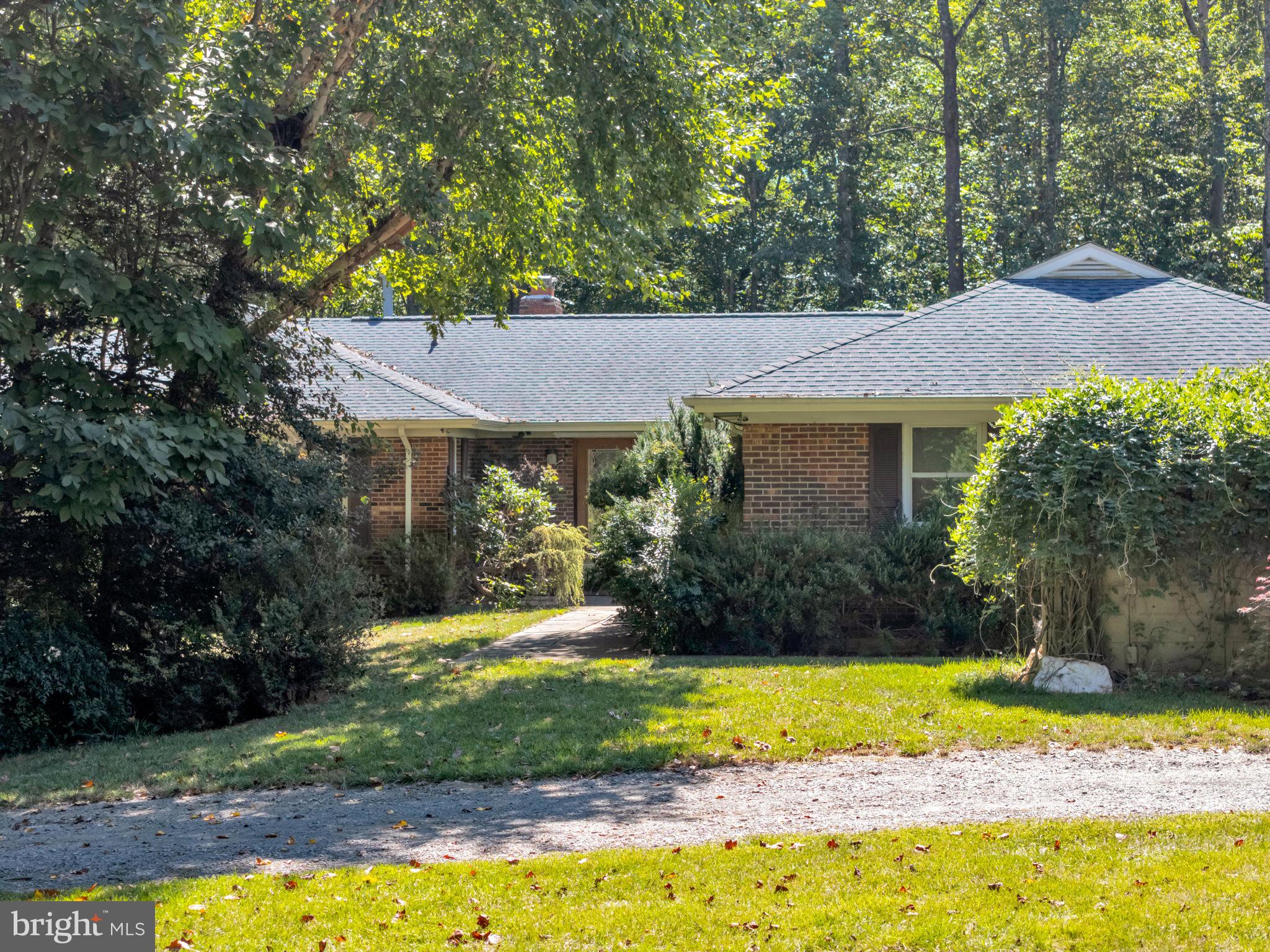 This 4 bedroom, 3 ½ bath, one of a kind Ranch sits on top of a hill with 2 acres of a private, wooded yard, and large boulders artistically placed to enhance the natural setting.  The driveway is compatible for large trucks with a 16-foot wide gateway. A large gravel driveway circles the house, providing parking and private entrance to a recently renovated apartment or in-law suite on the lower level.  Three separate attics.  Gorgeous setting with hundreds of red buds, azaleas, and hollies.
Garage -- This property could support a home business with upgraded and insulated 50 amp 2-car garage, ¾” plywood walls, lots of shelving, 12 2x4 LED lights, 6” re-enforced concrete slab at the entrance, an oil-changing pit, and storage area in an attic above the garage.
Kitchen – vaulted ceiling with real wood beams, skylight, large ceiling exhaust fan over an island stove, solid wood pantry, bay window, oak cabinetry, recessed LED lighting.
Living Room – sunken living room with 14’ vaulted ceiling, two skylights, solid oak flooring, brick fireplace with inserts, floor to ceiling 12’ glass door with walk-out deck, view of the woods with no house in sight.
Master Bedroom – very large with two walk-in closets, 3 large windows overlooking the woods.
Two Guest Bedrooms – each with 3 windows and views of the beautiful yard setting.
Two Guest Bathrooms – each exquisitely remodeled with skylight niches, granite and glass tile, stainless steel accents.
Main Level Laundry Room – skylight, 2-compartment stainless steel sink with kitchen spray hose.
Apartment or In-Law Suite – Framed in custom oak with sliding oak doors with glass entry door.  Windows have top down – bottom up blinds. Two closets, full kitchen, stained-glass windows.
Front Entrance – Oak framed, stained-glass, double doors.