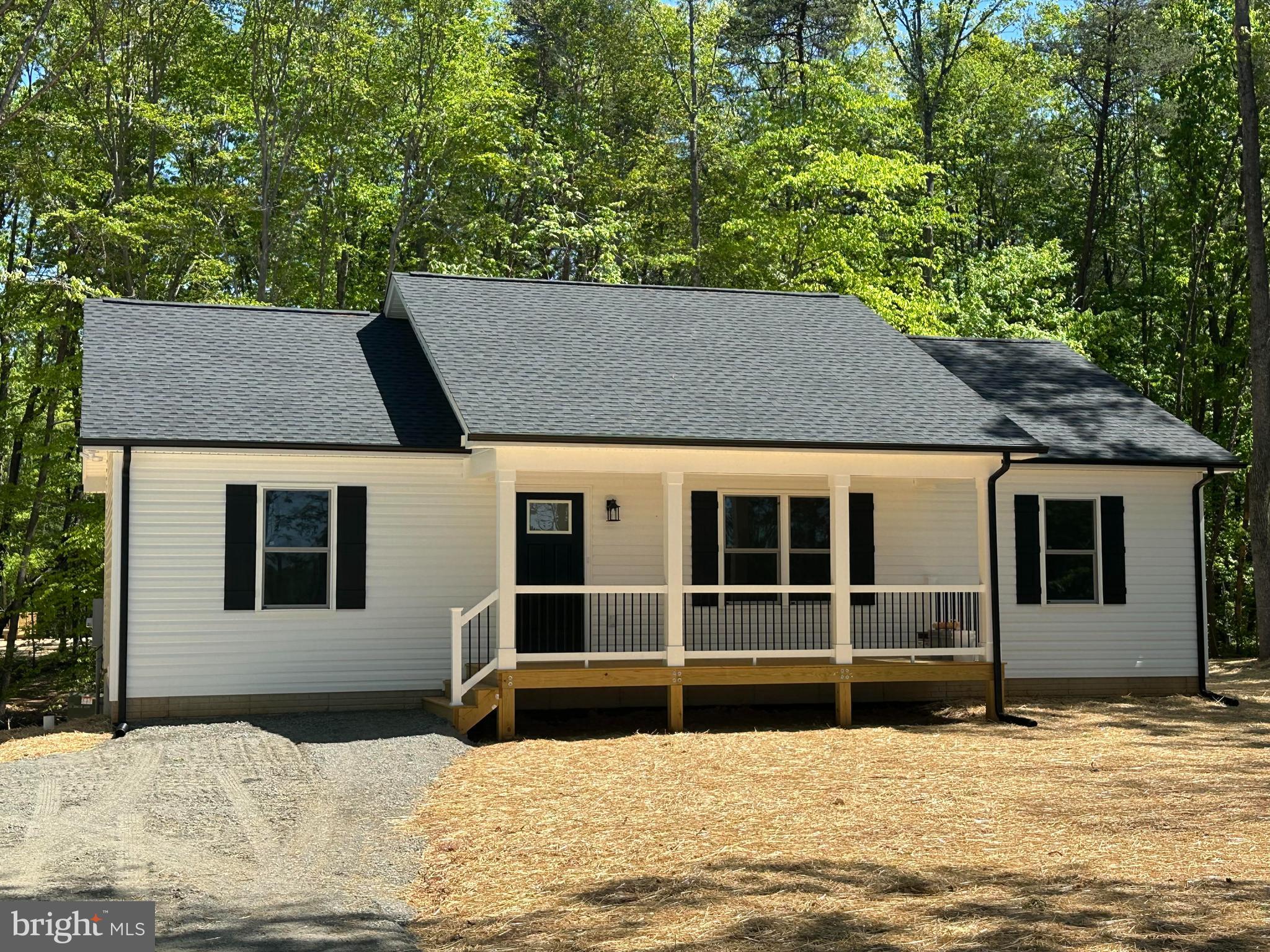 Beautiful Rambler Tucked Away on 2 Acres -  Just Completed and ready for you! Open floor plan with vaulted ceiling in the Kitchen/Dining/Great Room area of the home.  Rich LVP flooring throughout the entire home.  Kitchen displays a large granite center island, gleaming white cabinetry, stainless steel appliances and double sink.  Primary Suite complete with walk-in closet and full bath with double vanity.  Two additional spacious Bedrooms balance out the opposite end of the home.  Both baths offer granite countertops tub/shower combos. Thoughtfully designed utility room offers pantry, coat/storage closet and ample room for a full-sized washer and dryer. Sit for a bit on the covered front porch, adorned with metal pickets and easy to maintain vinyl railings.  Relax on the rear deck or invite your friends/family for a backyard BBQ - plenty of space to enjoy! The black gutters/downspouts, shutters and door really make this charming home pop!!