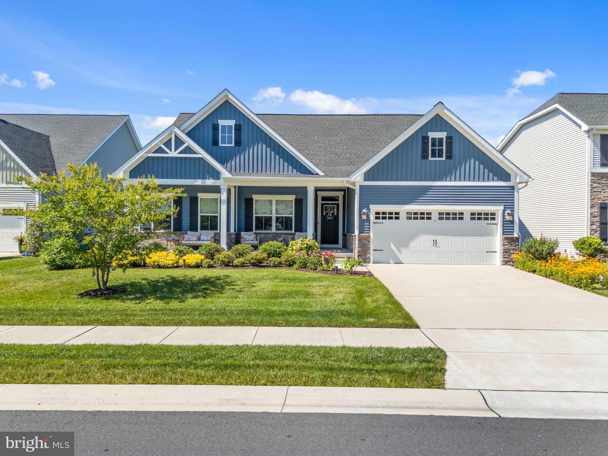 Experience effortless coastal living in the highly desirable Seagrove community, where an active adult lifestyle is paired with an unbeatable location just 6 miles from the Bethany Beach Boardwalk. This beautifully maintained coastal contemporary home offers nearly 2,000 square feet of thoughtfully designed living space, complemented by a welcoming front porch and a covered rear porch perfect for relaxing or entertaining. Best of all, lawn care is included in the HOA, giving you more time to enjoy everything coastal Delaware has to offer.

The beautifully landscaped, fenced backyard backs to peaceful community open space, creating a private setting to unwind. Inside, the gourmet kitchen is designed to impress with quartz countertops, stainless steel appliances, a pantry, upgraded pendant lighting, and recessed LED lighting. The spacious, open concept living area is filled with natural light and highlighted by an elegant tray ceiling, while light-toned luxury vinyl plank flooring and Craftsman-style doors add timeless coastal charm throughout the main living areas and primary suite.

The spacious primary suite offers direct access to the covered rear porch, two generous walk-in closets, including one with custom built-ins, and a beautifully appointed ensuite bath featuring dual vanities with upgraded fixtures and a seamless glass walk-in shower. Ceramic tile flooring enhances both bathrooms and the laundry room, while a convenient mudroom entry from the garage and a full-size washer and dryer add everyday functionality.

Move-in ready and meticulously maintained, this home also includes access to Seagrove's outstanding amenities, including a clubhouse, fitness center, outdoor pool, pickleball and bocce courts, firepit, and more. Ideally situated just 2 miles from Cripple Creek Golf & Country Club, 3 miles from Holts Landing State Park on the Indian River Bay, 4 miles from Bethany Bay Golf Club, and only minutes from Delaware's award-winning beaches, shopping, dining, and everything the coastal lifestyle has to offer.
