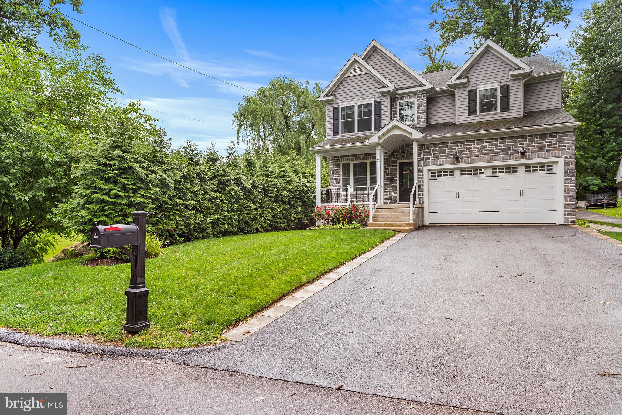 Welcome to 1211 Fairview Avenue, a stunning, custom-built home situated on a peaceful, country-like property on a secluded street in Haverford Township. Boasting over 3,000 square feet of luxurious living space, this remarkable home showcases superior workmanship, significant upgrades, and an array of custom features that create a warm, comfortable, and elegant atmosphere throughout. Step inside the formal foyer and be greeted by an open floor plan adorned with wide plank hardwood floors, custom millwork, recessed LED lighting, and soaring 9-foot ceilings. The heart of the home is a spectacular, oversized kitchen designed for the culinary enthusiast. It features a massive quartzite center island, premium upgraded appliances, and cabinetry, seamlessly adjoining a sun-filled breakfast area and a cozy family room centered around a beautiful gas fireplace. A first-floor bedroom with a huge walk-in closet sits next to a full bathroom. A mudroom with custom boot bench and garage access completes the main level.
Upstairs, the home offers 4 large bedrooms and 3 elegant bathrooms. The spacious primary suite is a true retreat, highlighted by an elegant tray ceiling, spacious dual walk-in closets, and a spa-like bathroom. One of the additional bedrooms has an en-suite bathroom as well as a walk-in closet.  Two more generously sized bedrooms with large closets share access to a hall bathroom which features an oversized double vanity and separate bath/water closet room. Upstairs laundry is conveniently located at the top of the stairs. The lower level features a massive full unfinished basement with 9-foot ceilings and egress window, offering incredible possibilities for a future home theater, gym, or additional living space. Outside, step onto your private rear deck with retractable awning, overlooking a serene, wooded lot—the perfect tranquil setting for morning coffee or evening entertaining.  The fully fenced rear yard  is finished with custom hardscaping and a detached storage shed with rollup door. The home also includes an attached two-car garage with epoxy flooring and an EV charger for maximum convenience as well as a whole house generator. Located in the award-winning Haverford Township School District, this exceptional property offers the perfect blend of a quiet neighborhood feel with easy access to local shopping, major roadways, dining, and public transportation. A home of this caliber, lot size, and location is a rare find. Put this home on your list—you will not be disappointed! Schedule your private showing today.