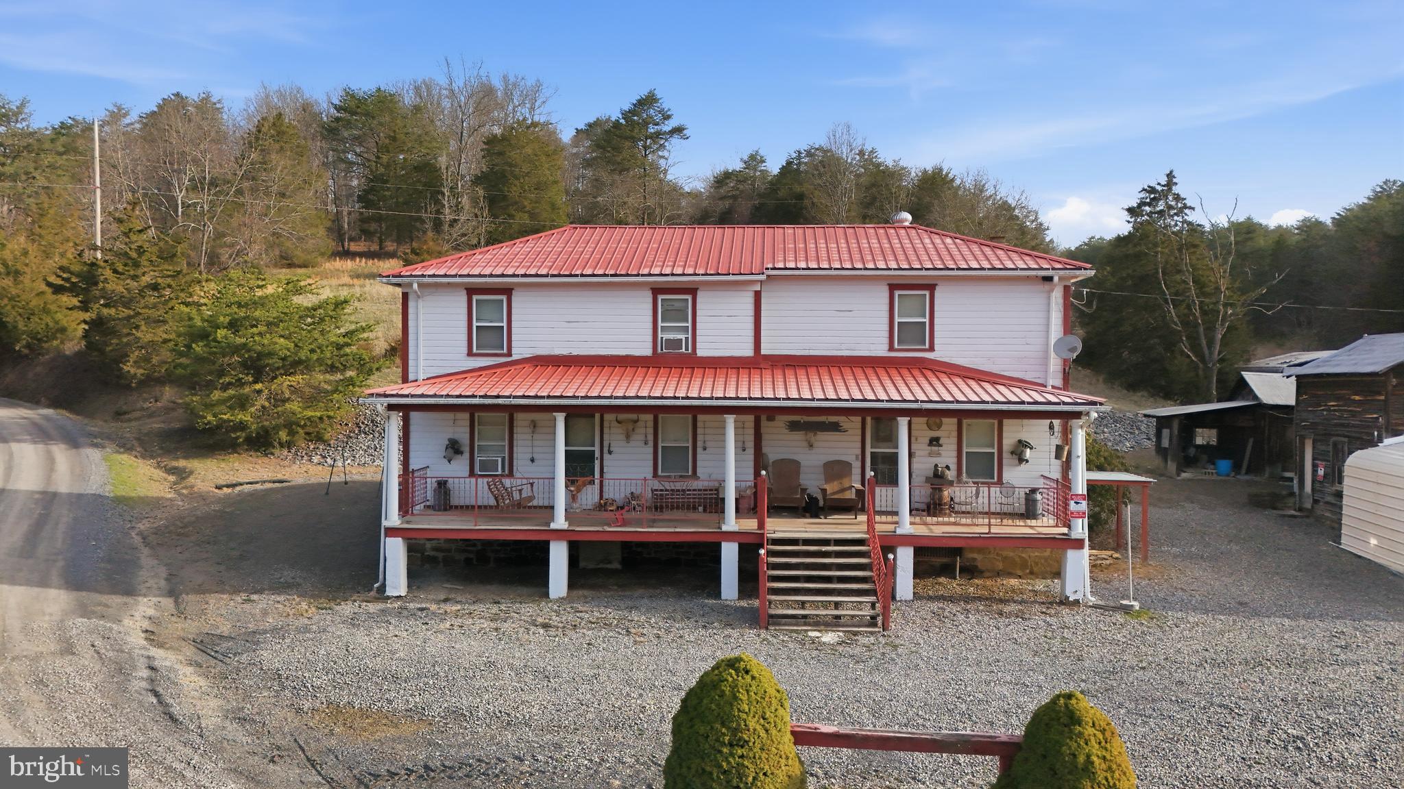 Real land, real water, and real hunting. This 42.13-acre unrestricted West Virginia homestead is tucked into a quiet hollow, surrounded by farmland, and set up the way a country property ought to be. With a stocked pond, covered pavilion, farmhouse, detached garage, barn, and a long stretch of county road frontage that allows easy access from multiple points, this is the kind of place that works as a weekend retreat, hunting property, or full-time move to the country. The land is the biggest draw. A fully stocked pond with a pier and covered pavilion gives you a ready-made place to fish, relax, and spend your evenings. The acreage offers a strong mix of open ground, woods, and wildlife habitat, making it a natural fit for serious hunters and outdoorsmen. Deer, turkey, and bear all use this area, and the property has the kind of feel that is getting harder to find. The farmhouse is authentic, functional, and full of character. This traditional gem offers 4 bedrooms, 1 full bath, a kitchen, dining room, living room, and sunroom, along with the kind of details that make it feel like a true country place instead of just another house. Inside you will find cedar-lined walls in one bedroom, a built-in bar in the living room, a wood-fired cook stove, built-in dining room pantries, and a full walk-in freezer ready for game, beef, or long-term storage. The detached garage and barn add real utility and make the property even more practical for equipment, storage, shop space, or farm use. The long county road frontage is another major plus, giving the property easy access and flexibility that many mountain tracts simply do not have. Places like this do not come along every day. It has the ground, the water, the improvements, and the kind of honest West Virginia character that buyers are always hoping to find. If you have been looking for a property you can use, enjoy, and hold onto for years, this one is worth a hard look.