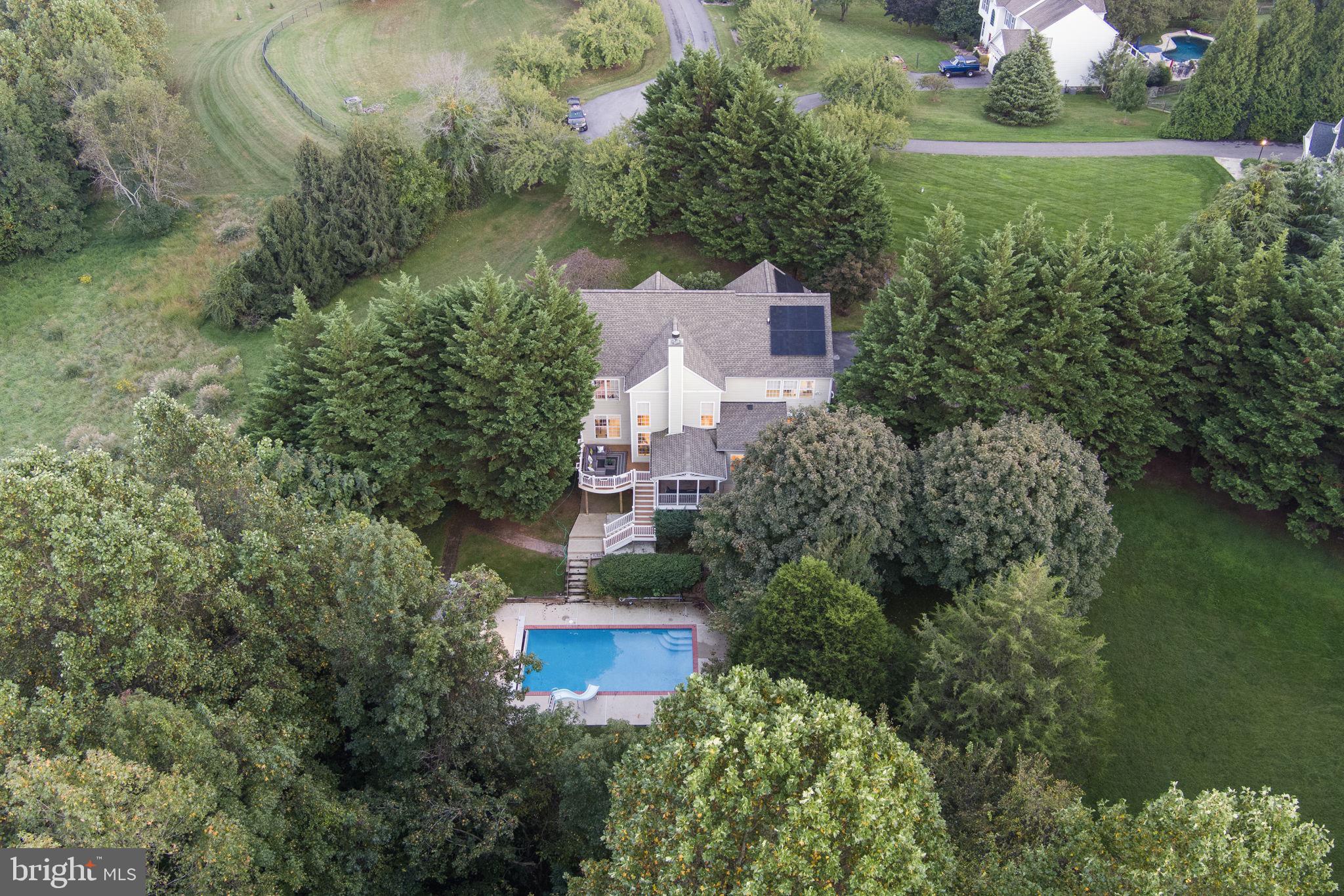 Discover your own private sanctuary on this stunning 1.16 acre cul-de-sac lot in the highly sought-after Carr's Grant community. This colonial-style home offers privacy, comfort, and outdoor living, with a fenced inground pool, charming pool house, and mature trees providing natural screening.


--Thoughtfully Designed Living Spaces:
Enter through a welcoming foyer flowing into a private office, formal dining room, and bonus room. The impressive 2-story family room features tall windows and a cozy fireplace. The open kitchen includes an eat-in dining area and flows to the screened porch and deck, creating ideal entertaining space.


--Comfortable Accommodations:
The upper level provides four well-appointed bedrooms and three full bathrooms, including a primary suite with elegant tray ceilings. The fully finished basement offers an additional bedroom, full bathroom, and spacious recreation room with fireplace and walk-out access to the backyard and pool area. 



--Outstanding Outdoor Living:
The property features a private inground pool with pool house for entertaining and storage. Multiple outdoor spaces including screened porch, deck, and patio provide endless options for relaxation. A spacious driveway and side-entry 3-car garage ensure convenient parking.