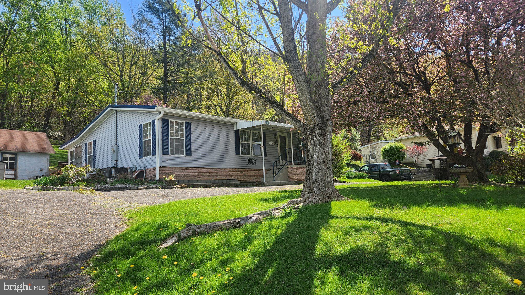 One owner, well maintained home.  Single floor living.  Paved driveway with one car detached garage.  Enclosed back porch.  Sunset views from the front of the house.  No city taxes but public utilities!  Short drive to city amenities. New metal roof on back porch and new gutters in 2025-2026.