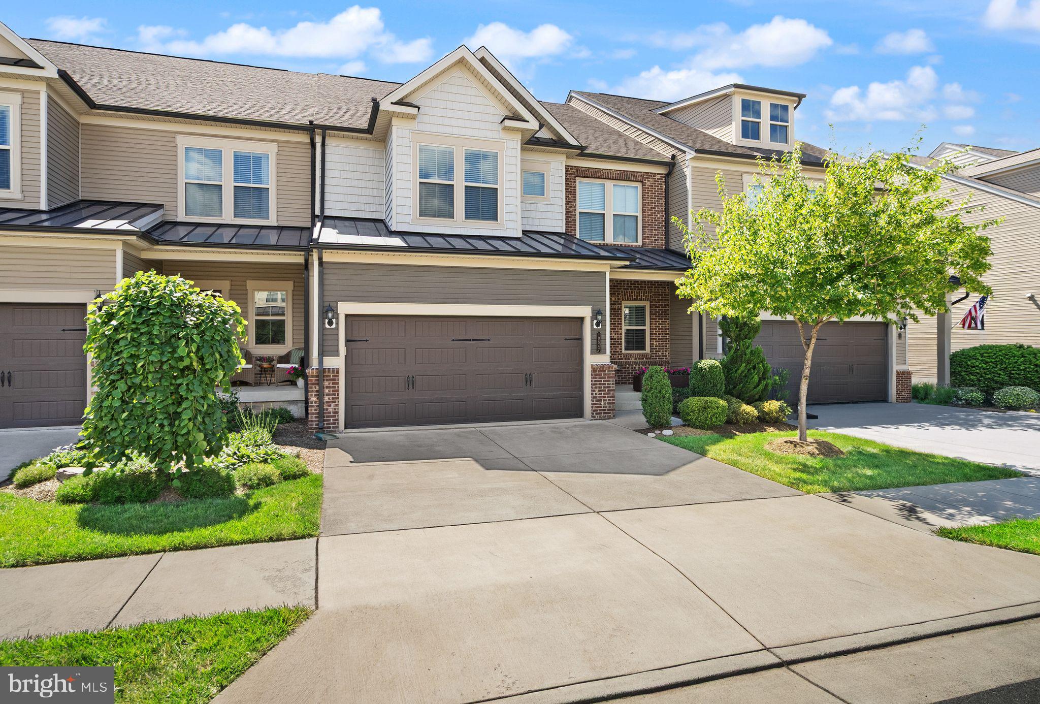 Welcome to 19847 Silvery Blue Terrace, a beautiful townhouse in Ashburn’s sought-after Active Adult 55+ community of Lexington 7. This property is located on a premium lot with picturesque views of the protected woods, open common area, and the pond, eastward facing with breathtaking sunsets from the back porch. Built in 2019, the Aston model boasts 3400 finished square feet on 3 levels with 2 car garage as well as two driveway parking spaces. Entering from the covered front porch, you are greeted with an open layout where entertaining is easy and hardwood floors run the expanse of the main level. Here you will find a gorgeous kitchen with white cabinetry, granite countertops, a spacious island, stainless steel appliances, to include a gas cooktop and range hood. Bright and light with soaring ceilings, the dining room and family room lead to a large composite deck with a retractable awning and stairs to the lower level. The main level primary suite includes an ensuite bath with an oversized frameless glass doored shower, double vanity, and an enormous walk-in closet. The powder room, laundry room, and an office complete the main level. Upstairs are two generously sized bedrooms that share a beautiful hall bath, plus a second family room, and large office or storage room. The lower level recreation room is 800 square feet of finished living space with a half bath and walk-out to the patio. There is also a big unfinished space designed to be a 4th bedroom along with a bathroom rough-in. Freshly painted, Silvery Blue is ready for its new owner to enjoy! This community has a popular pickleball court and is walking distance to restaurants and shops across the street as well as the trails along the Potomac River. One Loudoun is minutes away along with two silver line metro stops, Dulles Airport, and INOVA hospital center.