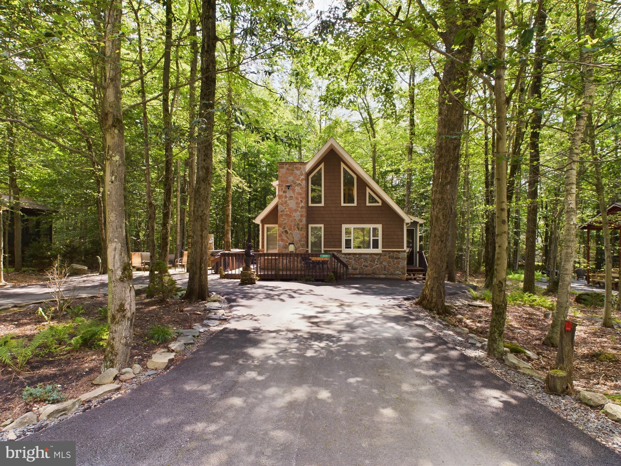Two-story Chalet in the gated, amenity-filled community of Arrowhead Lake. This 4 bedroom, 2 bath home has a grand second floor master suite with it's own full bath and walk-in closet. The main floor features a foyer with coat closet, cathedral ceilings, propane fireplace with marble surround in the living room, updated kitchen with tile backsplash and breakfast bar, plus a full size washer/dryer off the kitchen. Enjoy the outdoor scenery from the deck and the privacy of lots of open space behind the house. Hot Tub and fire pit.  Walking distance to the heated Choctaw Pool!

Arrowhead Lake is a gated community with security, 3 heated swimming pools, 2 lakes for fishing/swimming and boating, tennis courts and bocce ball. Many of these activities have occurred over the years including bonfires, carnival, Zumba, water aerobics, swim team, potluck dinners/breakfast and summer camp.