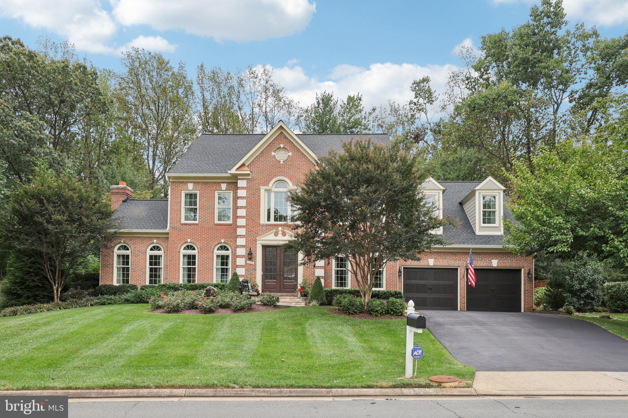 Stately brick-front colonial in Reston offering striking curb appeal and a beautifully designed backyard oasis. With magazine-worthy décor throughout, this home feels professionally curated at every turn. It features five bedrooms, four and a half bathrooms, and three finished levels filled with natural light, high ceilings, and refined architectural details.

Enter through the custom 8-foot ProVia front door into a dramatic two-story foyer with marble flooring and elegant moldings, setting the tone for the thoughtfully styled interiors. Formal living and dining rooms flank the foyer, each finished with designer touches that feel straight out of the pages of a luxury home magazine. Select wall coverings featured in the home are hand-painted by a professional artist, adding a truly custom and elevated element rarely found.

A private home office sits behind glass French doors and includes a gas fireplace, creating a sophisticated yet inviting workspace with editorial-level design.

The kitchen is the centerpiece of the home and a true showstopper, featuring Elmwood cabinetry, Taj Mahal quartzite countertops, a 48-inch Dacor Modernist Pro gas range, built-in Dacor refrigerator, Bosch dishwasher, drawer microwave, hardwood flooring, and timeless subway tile backsplash. Every finish has been carefully selected, resulting in a space that looks both high-end and effortlessly timeless. The adjacent family room continues the magazine-quality aesthetic with a new gas fireplace, reclaimed wood mantel, and stone hearth.

Just off the kitchen, a sun-filled sunroom with custom window tinting and French doors opens to the Trex deck, complete with a built-in Delta Heat gas grill and bar—an outdoor extension that feels as thoughtfully styled as the interior.

The attention to detail continues into the garage, which has been elevated beyond the ordinary with epoxy floors, built-in storage, slat walls, overhead storage, and new garage doors and openers—both functional and visually polished.

The fully finished walk-up lower level offers a spacious recreation and entertaining area with wet bar, a bedroom and full bath, a large laundry room, and a custom wine room, all designed with the same editorial-level finishes found throughout the home.

Upstairs, the primary suite is a private retreat featuring a custom walk-in closet and a spa-inspired bath with curbless walk-in shower, soaking tub, and heated tile floors. One additional bedroom enjoys its own private en-suite bath with marble heated floors and a walk-in closet, while two more bedrooms share a beautifully finished hall bath—each space styled with intention and visual cohesion.

Significant upgrades include professional landscaping, a new roof, gutters, HardiePlank siding, and skylights (2020), as well as new Carrier HVAC systems with humidifiers and a new water heater (2022).

A rare offering that combines timeless architecture, exceptional craftsmanship, and interiors that truly look like they belong in a design magazine—because in many ways, they do.