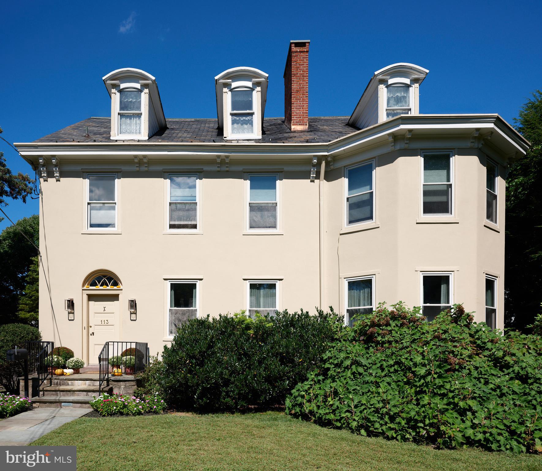 Originally constructed in 1834, consisting of stucco over stone, this handsome home had a 3 story addition in the 1880s, and a breakfast room addition in 1995.  The property sits behind a gracious stone wall, accented by wrought iron fencing, with the lot stretching from Penn Street to Mercer Street - where access to the 2 story garage/barn is located.  Ideally situated within walking distance to the heart of town - Starbucks is 2 blocks, Rocco's as well, and the ever popular Newtown Theatre is a 7 minute walk.  The interior features a traditional floor plan.  The living room has a gas fireplace, with a traditional mantel - in a style characteristic of vernacular Newtown style - as well as a built-in china cupboard.  Wood floors are found in most of the public rooms - with the exception of the kitchen area, which features comfortable cork flooring.  The dining room, part of the 1880s addition, is grand in size and one wall of stone indicates the exterior of the original 1834 construction.  A large family room, with access to the rear brick patio, was originally the kitchen - based on the walk-in fireplace.  The remnants of the beehive oven are clearly visible in this large fireplace.  The kitchen is a gourmet delight - with Miele appliances, including 2 wall ovens, a warming drawer, dishwasher, side by side 48" refrigerator/freezer.  A large island houses the gas cooktop and heavy duty drawers can hold an array of pots/ pans and small appliances.  The cabinetry is custom with inset doors and soft close drawers.  The 1995 breakfast room addition has atrium doors to the brick patio and features multiple skylights with remote controlled shades.  This space also features the powder room and the laundry/butler's pantry/mud room.  A back stairway off the kitchen leads to the bedrooms.  There are 4 bedrooms on this upper level - all with wood floors.  The primary bedroom features 2 closets.  There are 3 additional bedrooms - one of which features 3 closets with built in drawers, and another with a cedar closet.  Two full baths are located on this level - all with brass fixtures.  One bath has a jetted tub with curved surround and a custom vanity recommissioned from an oak dresser, and the other bath features a walk in shower with seamless shower doors and a free standing sink with brass legs. The third floor has original flooring, plastered walls in the main room as well as a cedar walk-in closet, large mechanical/storage room, and spacious addition spanning the 1880 addition.  This space would lend itself to a great bedroom suite.  
The view of the house from Penn Street gives the impression that the house does not have a driveway or off-street parking.  A special feature of the house is the fact that it fronts on two streets - Penn Street and Mercer Street.  The Mercer Street entrance features a very large parking area as well as a large 2 car garage/barn with second level storage.  Entry to the rear yard is through the gated fence where a brick walkway leads you to the spacious patio and screed gazebo as well as kitchen and family room entrances.  Ideally located within walking distance of all that Newtown Borough has to offer as well as 3 blocks to Septa Bus Line, 5 miles to rail station, and 2 miles to 95/295,