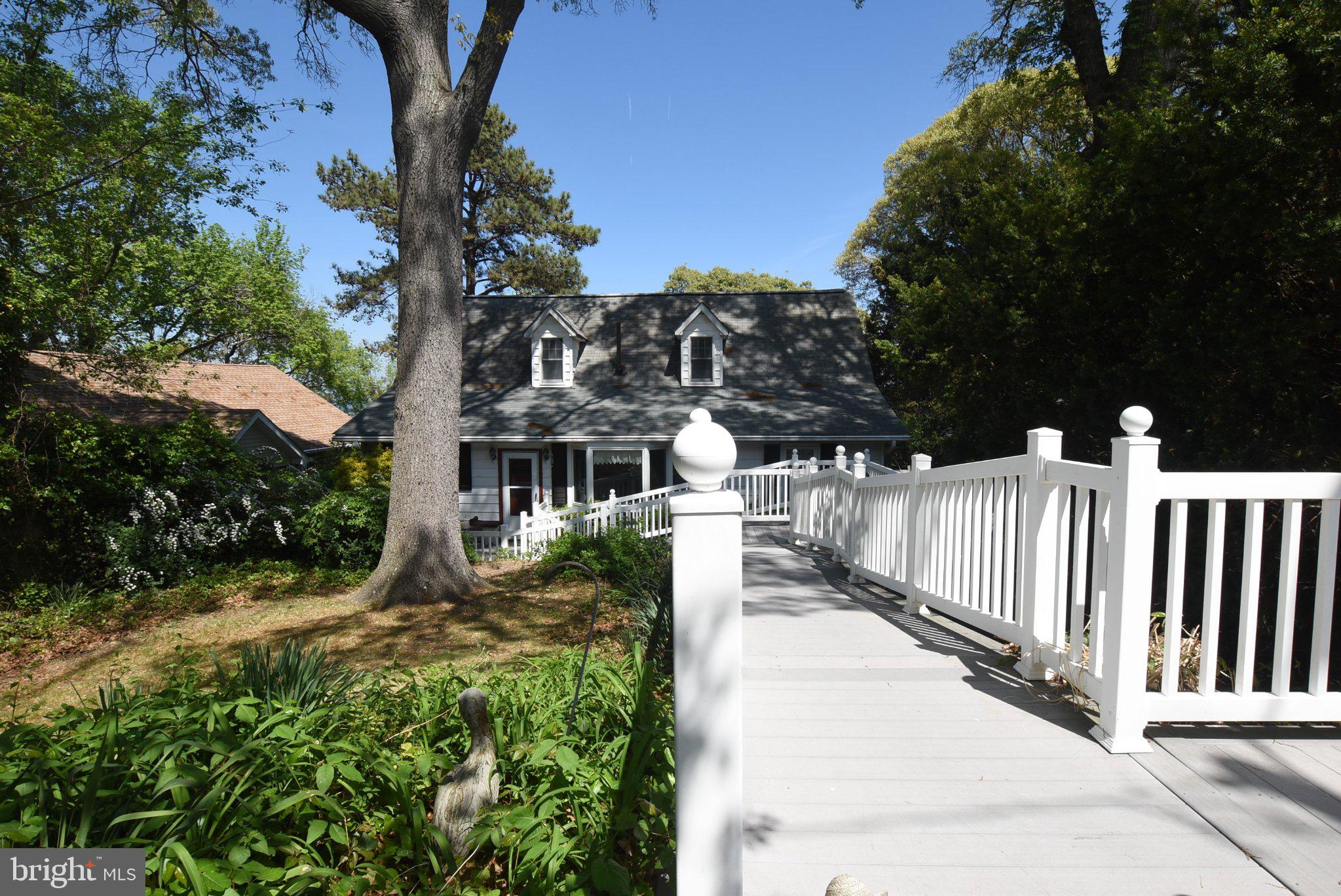 Run!!! Don't Walk!! This exquisite Cape Cod residence, nestled on the Shores of Calvert Beach, offers a harmonious blend of comfort and bay living, perfectly positioned along the banks of the picturesque Chesapeake Bay. With 2,379 square feet of thoughtfully designed living space, this home features four spacious bedrooms and three full bathrooms, ideal for both relaxation and entertaining. Step inside to discover a warm and inviting interior, highlighted by a cozy gas fireplace that serves as the heart of the living area. The galley kitchen is equipped with a wall oven, cooktop, and a refrigerator/freezer, making meal preparation a delight. A charming breakfast area and a formal dining room provide versatile spaces for gatherings, while a second kitchen in the basement adds convenience for separate living. The finished basement, accessible via a side entrance and interior entrance, offers additional living space and a workshop, catering to various lifestyle needs. Outside, the property boasts a generous 0.63-acre lot with no thru street, ensuring privacy and tranquility. Enjoy breathtaking water and bay views from your own private beach, perfect for relaxing, fishing or launching your watercraft from the private community beach and ramp. The sandy beach invites leisurely strolls and fishing adventures, while the expansive outdoor space is ideal for gatherings or quiet evenings under the stars. With a detached garage accommodating two vehicles and driveway parking, this home combines functionality with coastal charm. Experience the ultimate bayfront lifestyle in this remarkable property. Within a short commute to shopping and entertainment. Close Proximity to Washington DC, Joint Base Andrews, Pax River and Annapolis.