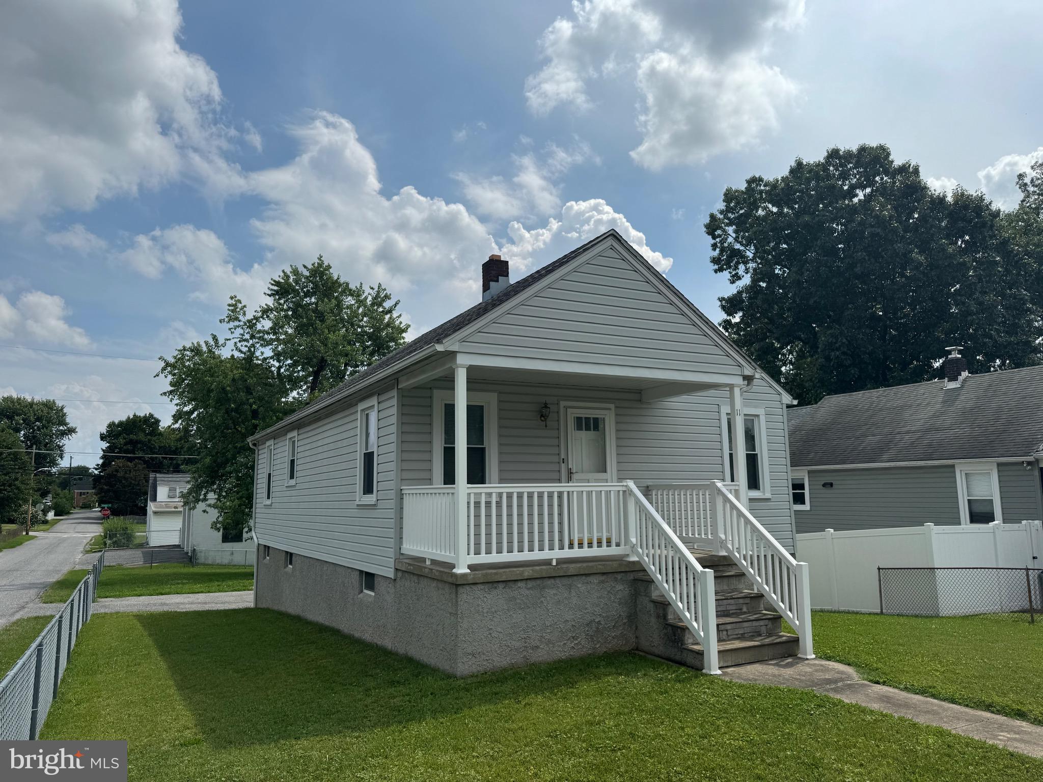 You will love this completely updated three bedroom one bath home. It sits on a corner lot with a fenced in yard. The house had a a covered front porch and a deck off the back. With wood floors throughout and an updated kitchen with all new appliances. Off of the kitchen is a large sunroom with vaulted ceilings and skylights, that can be used as a dining room. All of the work has been done for you. The basement has great potential with high ceilings and a walkout at Ground level. One year home warranty included.