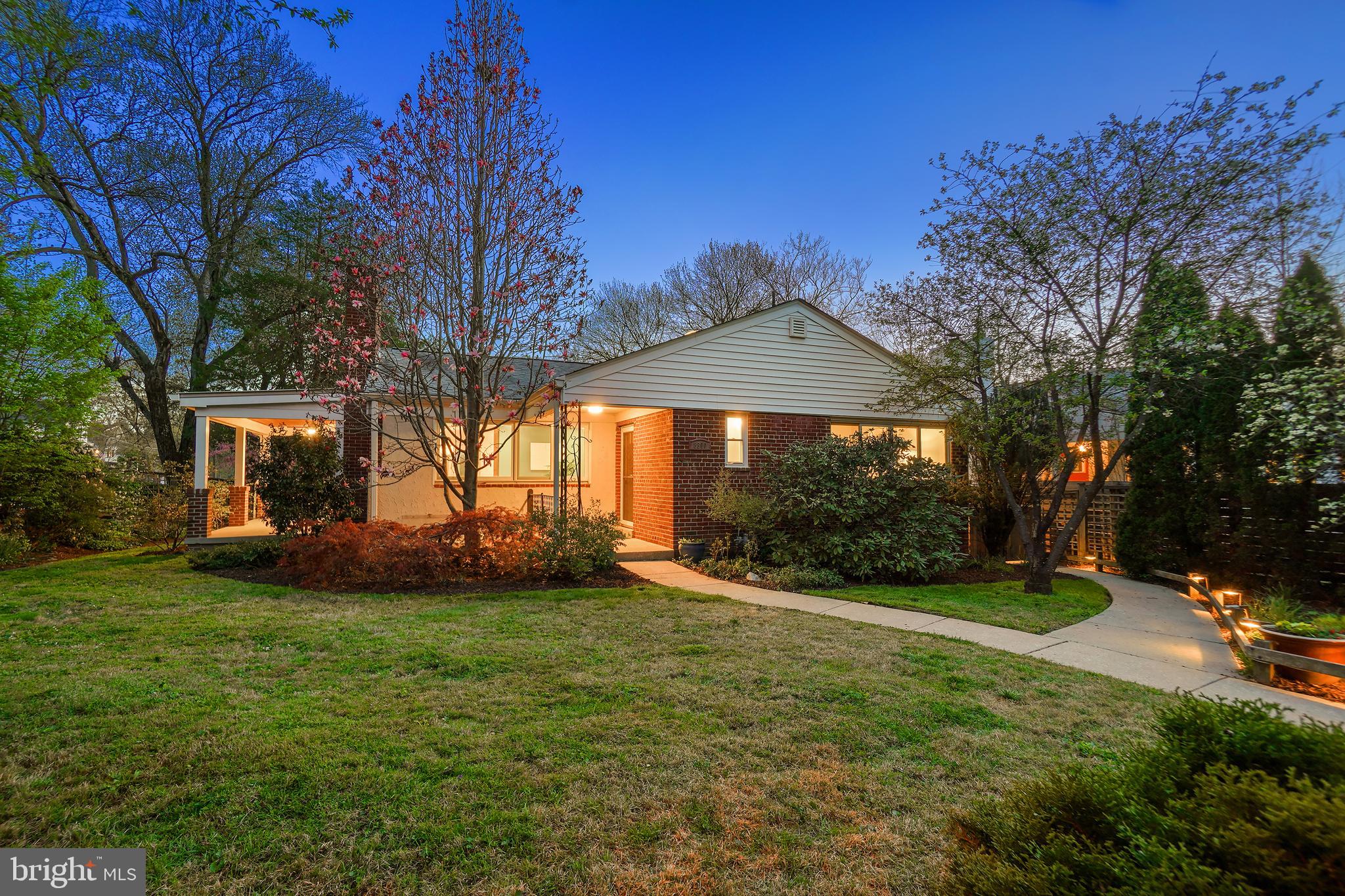 Welcome to this exceptional Mid-Century rambler with a fully permitted walk-out apartment, ideally situated in scenic Rock Creek Forest, directly across from Rock Creek Pool. This beautifully maintained home features a spacious, light-filled interior, large windows, hardwood flooring, and picturesque outdoor spaces.

A charming covered front porch welcomes you inside, where the main level boasts a sun-drenched living room with expansive windows and a fireplace with a stove insert. The open dining room offers seamless access to the covered side porch and flows into the renovated kitchen. Designed for both style and function, the kitchen features granite countertops, rich wood cabinetry, updated appliances, ample prep space, and direct access to the back deck. This level also includes three bedrooms and two full bathrooms, including a bright primary suite with a private bath and a wall of closets.
The impressive walk-out lower level provides incredible versatility, serving as either additional living space or a self-contained apartment. This spacious, permitted one-bedroom unit has its own exterior entrance, ceramic tile flooring throughout, a bright living area with large windows, a full kitchen with a pantry and built-in storage, a full bathroom, and a generous bedroom—ideal for an in-law suite or rental income. A shared laundry area is conveniently located on this level.
The private, fenced backyard is a tranquil retreat. The picturesque corner lot offers multiple enchanting and useful outdoor spaces, including a rear deck, covered side porch, and a driveway. This expansive setting is enhanced by lush landscaping, featuring a stunning Cherry Tree, a Weeping Japanese Maple, a Magnolia Tree, and vibrant garden beds filled with colorful seasonal plantings. Additionally, the home is equipped with leased solar panels, providing an energy-efficient and eco-friendly benefit.
Perfectly located near the neighborhood swim and tennis club, this home is also just minutes from shops, restaurants, and Metro access. Nature lovers will appreciate the proximity to Rock Creek Park, offering miles of hiking and biking trails, ball fields, and the beloved Candy Cane City playground. Commuting is effortless with easy access to Connecticut Avenue, Beach Drive, East-West Highway, 16th Street, and I-495. A short drive brings you to the dynamic dining and entertainment hubs of downtown Bethesda and Silver Spring. This home is also part of the sought-after Bethesda-Chevy Chase High School cluster, which includes the prestigious International Baccalaureate Program.