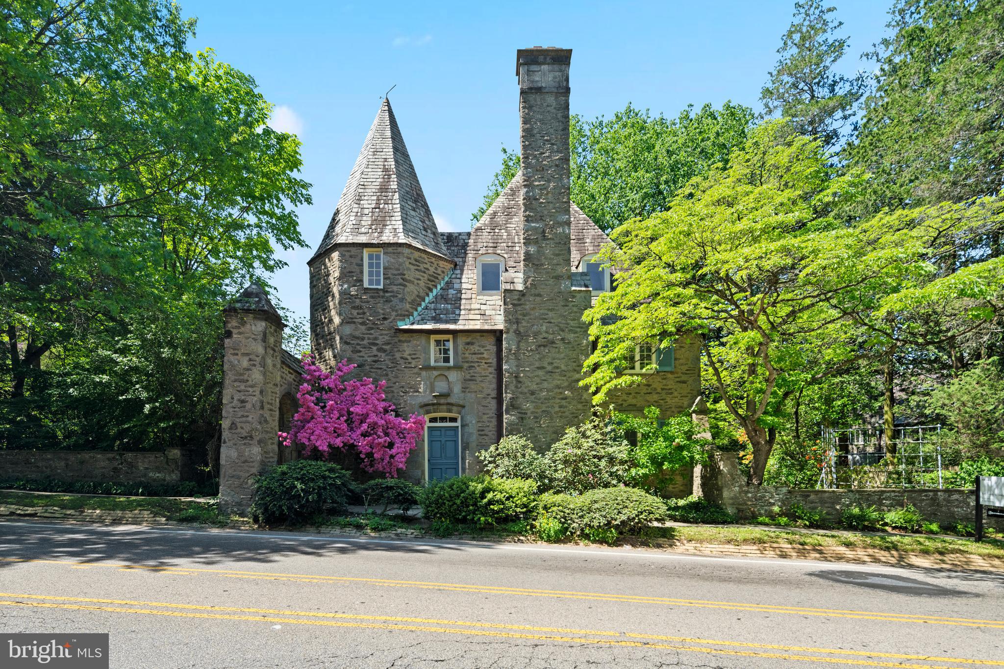 Welcome to one of Mount Airy's most enchanting and unique homes—one of only two mirrored gate houses in the iconic French Village Historic District. Tucked into a beautifully wooded neighborhood filled with French Norman Revival architecture, this three-story home is brimming with old-world charm, dramatic features, and elegant natural light.
As you step inside, you're immediately drawn into a spacious, sun-filled kitchen featuring fresh appliances and a large center island. Off the kitchen, a cozy study with its own fireplace offers a peaceful retreat, leading to a long hallway lined with a wall of French doors that overlook the lush gardens. At the heart of the home, the dining room—with its own terrace access—anchors the space, perfect for intimate dinners or summer gatherings. The living room is equally radiant, bathed in natural light and also opening to the terrace through graceful French doors.
One of the standout architectural elements is the dramatic curved staircase with raised ceiling, which elegantly winds from the first floor to the second. Upstairs, the primary suite sits just above the living room, offering privacy, ample space, and a peaceful view. The second floor also includes three additional bedrooms, with a large  full bath, and a long hallway that mirrors the first, again bringing in beautiful light through garden-facing fenestrations. One of the secondary bedrooms—located above the kitchen—offers a timeless wrought-iron balcony overlooking the rear gardens.
On the third floor, you'll find an ensuite bedroom, a laundry area and two bonus rooms that can become whatever your imagination desires—studio, storage, meditation space etc. Allow your visionss to become reality
The home also includes incredible gardens, filled with mature plantings, specimen trees and everblooming seasonal colors. The serene setting comes complete with a blue stone terrace, flowing koi pond, pebbled driveway and a detached garage.
Located in the historic French Village—a 24-home enclave built between 1924 and 1936—this house is part of a preserved piece of Philadelphia’s architectural history. While you'll feel transported to a European countryside, you're just steps from Wissahickon Valley Park and everything that Northwest Philadelphia has to offer.
This home is about light, elegance, and enchanting character. Don’t miss the opportunity to own a piece of history in one of the city's most romantic neighborhoods.
