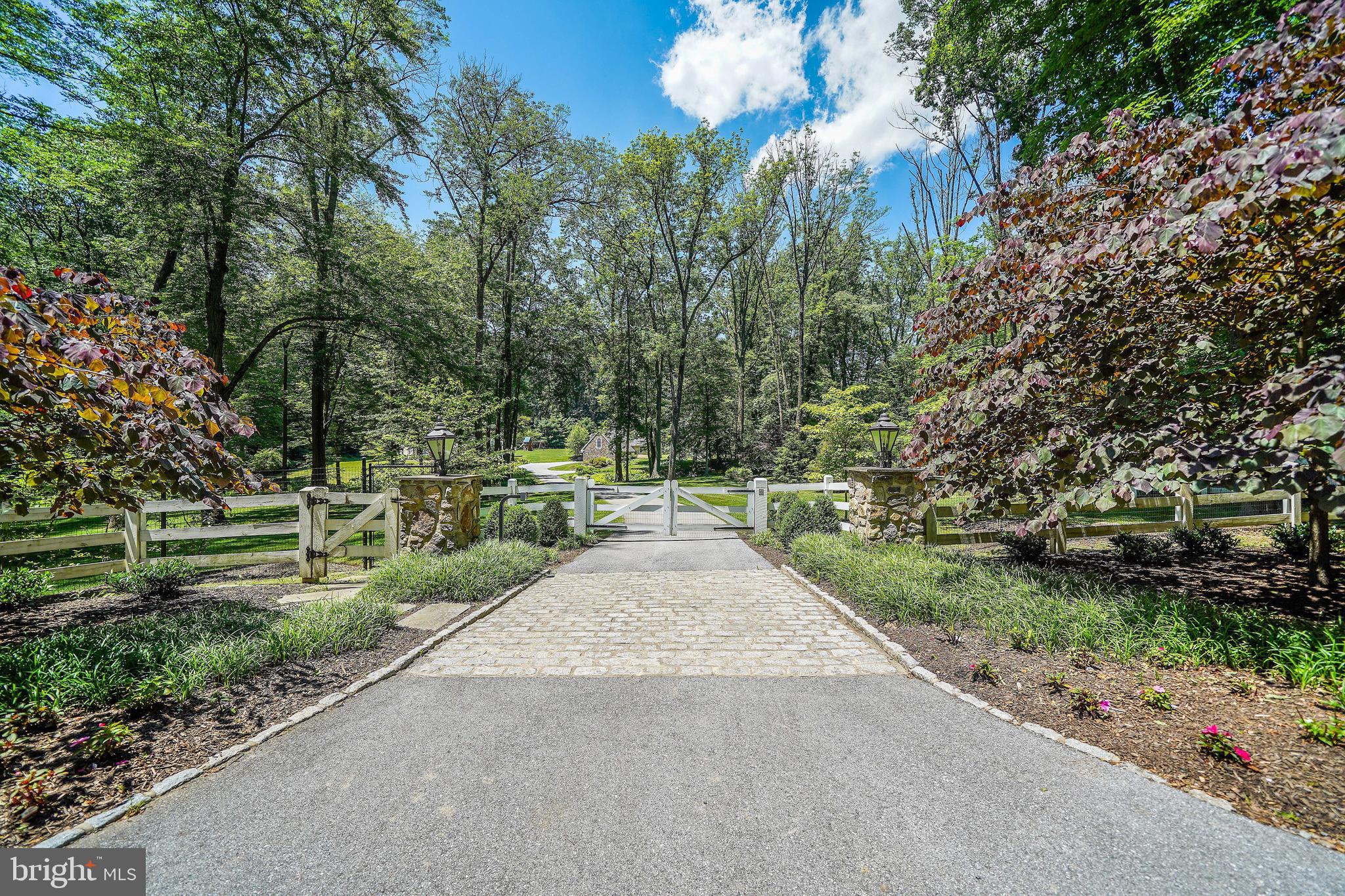 Elegance. Privacy. Comfort. Convenience. All four (and more) come together at 400 Dutton Mill Road, an exclusive estate nestled on 4.7 pristine acres in the prestigious Radnor Hunt community in Willistown. This secluded oasis features a 5,000+ -square-foot main house, ample outdoor space with landscaped gardens, winding walking trails, and a resort style pool, and stunning views of the surrounding countryside for the best in Main Line living.The gated entrance welcomes you up a stately driveway with the feeling of a country manor. But the highlight of this property is its abundance of meticulously cared for outdoor space and grounds that feature breathtaking scenes of the rolling countryside. The focal point of which is an impressive blue stone patio accentuated by the lush backdrop and linked to a nearby fire-pit with a relaxing seating area. Also, just steps away is a heated pool where you can make a splash or just refresh and unwind while taking in the panoramic backdrop of the pastoral property. Inside you'll find a light, airy atmosphere with no shortage of upgrades designed to impress and make your daily life a breeze. Meanwhile, one-of-a-kind design elements like custom mill work, luxury hardwood flooring, and artfully-crafted window moldings speak to a classic yet contemporary vibe. The chef-inspired kitchen features high-end appliances and granite counter tops, not to mention a propane fireplace in the eating area. From here you?ll find a spacious butler pantry that connects to an intimate dining room, French doors opening to a new patio, and a private, back staircase rise to your sleeping area. There?s also a new, over sized mudroom and storage area off the side entrance. The main family room welcomes you with warm wood accents, a stone, gas fireplace, and a wet bar and parlor area ideally suited for socializing over appetizers or after-dinner drinks. Sweeping windows bring in plenty of natural light throughout, as well as generous views of the native trees and vegetation. In addition to a bonus living area, tucked away you'll find a private corner office and a covered screened in porch where you can enjoy your morning coffee while checking emails or just taking in a good book. The second floor features four roomy bedrooms and three full baths.  The primary bedroom offers two custom closets, a cozy propane fireplace, and a sizable tile bathroom with a steam shower, a soaking tub, and double sink. There is also a sitting room that could be converted into a fifth bedroom.  In addition to three more bedrooms (including a princess suite), the upstairs has a large hall bath with double sink, and a laundry room accessible from both the hallway and primary bedroom. The finished basement is the perfect place for an extra playroom or theater room.   In addition, above the detached (and spacious) three-car garage is a fully finished living area and full bath that could be used as a pool house, au pair suite, or gym. Ideally situated on the Main Line, this retreat is offers low taxes and is just minutes away from quaint town centers and desirable shopping and dining destinations, not to mention the Amtrak Train station and schools that are regularly ranked among the best in the Philadelphia area and the nation. Great Valley  school district is one of top 10  public schools in the State of Pennsylvania.   Large properties and estates go on the market every day. Rare jewels amid historic and untouched acreage do not. Come home to elegance, privacy, comfort, and convenience. Come home to 400 Dutton Mill Road.