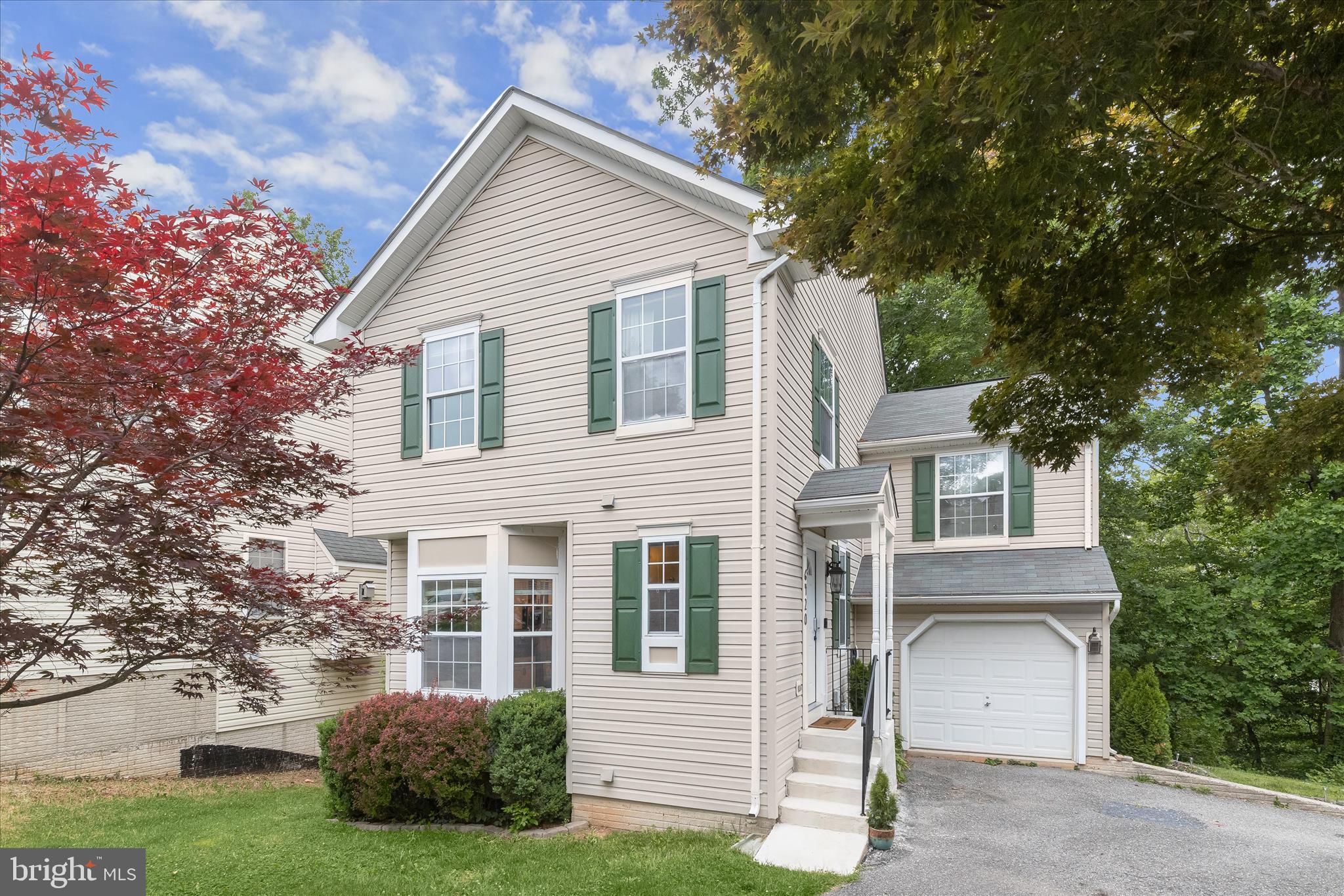 Welcome to 6420 Ivy Terrace, a beautifully updated single-family home offering over 2,400 square feet of thoughtfully designed living space in the sought-after Harwood Park community of Howard County. With 5 bedrooms, 3.5 bathrooms, and a picturesque setting back to Harwood Park, this exceptional residence seamlessly blends modern updates, timeless features, and natural beauty. From the moment you arrive, you'll appreciate the home's inviting curb appeal, fresh landscaping, and tranquil surroundings. Step inside to discover gleaming hardwood floors, soaring 9-foot ceilings, abundant natural light, and breathtaking views that create a warm and welcoming atmosphere throughout the main level. The open-concept living and dining rooms are accented by elegant crown molding and offer easy access to the rear deck, where you can enjoy your morning coffee overlooking the treetops while listening to the peaceful sounds of the stream that meanders through the rear of the property. The beautifully updated kitchen is designed for both everyday living and entertaining, featuring 42-inch cabinetry, granite countertops, stainless steel appliances, decorative backsplash, pendant lighting, a center island, a custom coffee bar, and a light-filled bow window that frames the stunning natural views. A convenient powder room completes the main level. Upstairs, retreat to the spacious primary suite featuring ample closet space and a luxurious en-suite bath complete with dual vanities, a soaking tub, and a walk-in shower. Three additional generously sized bedrooms and a full bath complete the upper level. The finished walkout lower level provides exceptional versatility, offering a spacious family room with direct access to the patio and backyard, where scenic views of the stream and surrounding greenery create a peaceful retreat. This level also includes a fifth bedroom, full bath, and laundry room, making it ideal for guests, multi-generational living, or a private home office. Additional highlights include an attached garage. Recent updates include kitchen and lower-level LVP flooring, microwave, painted kitchen cabinets, stove, refrigerator, HVAC, garage/ gym, and more! Ideally located near Harwood Park, playgrounds, basketball courts, community events, BWI Airport, Fort Meade, and major commuter routes including I-95, Route 295, and Route 100, this home offers the perfect combination of convenience, comfort, and natural beauty. Thoughtfully updated and impeccably maintained, 6420 Ivy Terrace is a rare opportunity to enjoy spacious living in one of Howard County's most desirable communities.