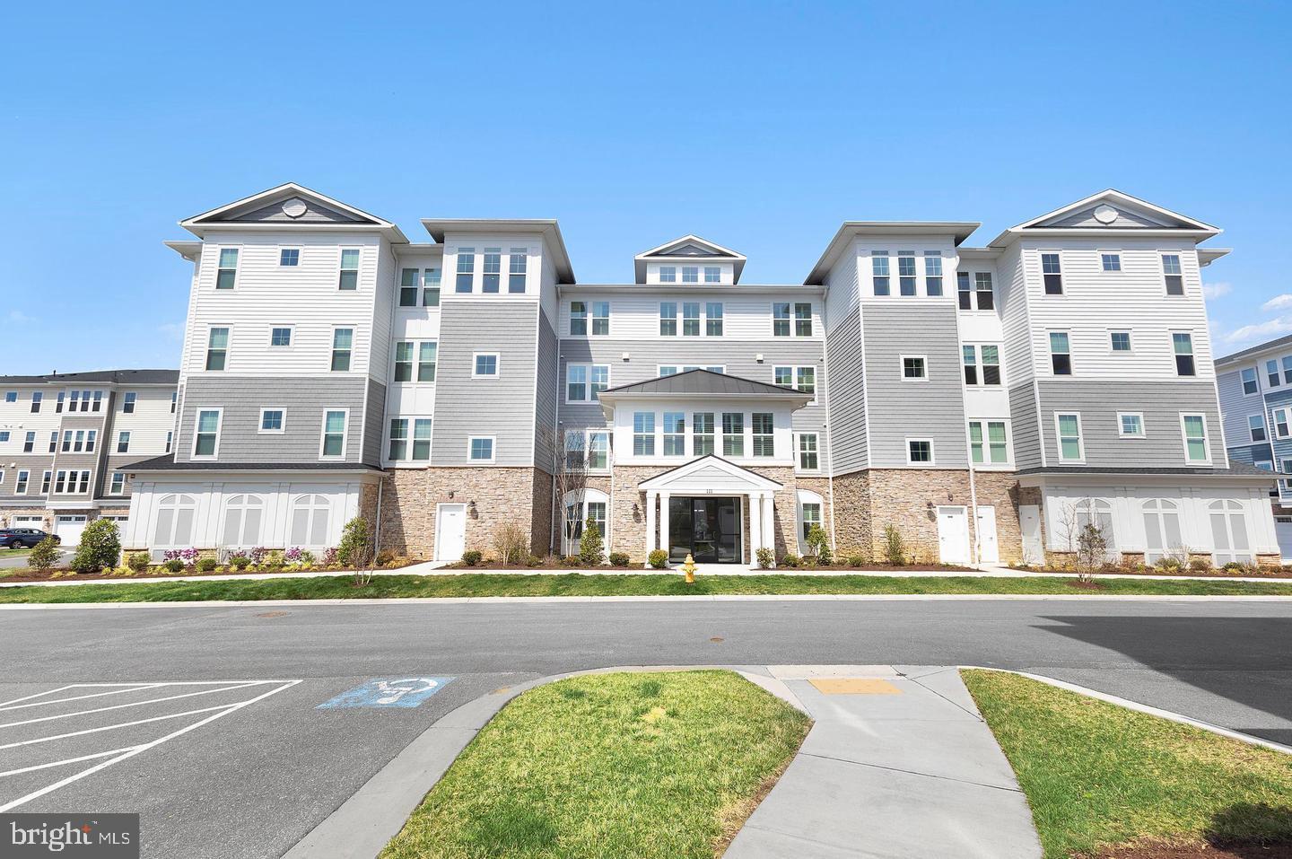 Welcome to this stunning 4th floor penthouse Severn condominium  with serene bay views! This end unit looks out over the walking trails to the water and trees.  The fabulous community center /pool / pier is a short 1 mile walk from your backyard.!  This unit also has the largest garage space in the the building, plenty of room for one car and storage, a refrigerator etc. There is also an additional inside storage room.  This 2600 Sq Ft home is flooded with natural light and has numerous quality upgrades including custom shiplap in most of the rooms, custom ceiling fans and dining room light fixture, custom built his and hers walk in closets. The primary bath has upgraded tile, shelving for more storage, mulitple shower heads and back and front lit vanity mirrors. The gourmet kitchen is designed to impress, featuring elegant quartz countertops,premium appliances and a Wolfe induction cooktop.  The island has been upgraded with shiplap as well.  Thoughtful upgrades continue throughout the entire home with custom blinds with remote control, a  gas fireplace,9 FT ceilings with tray ceilings in the living room and primary suite. A wet bar has also been added to the dining area.The large primary bedroom comes complete with a sitting area/office with exceptional waterviews.   It also offers  custom designed his -and -her closets that provide both style and storage. This unique residence offers a peaceful setting where you can relax and enjoy the ever-changing waterfront vistas. Whether you are enjoying your morning coffee or entertaining guests, this home offers the perfect blend of sophistication, comfort, and low maintenance waterfront living.