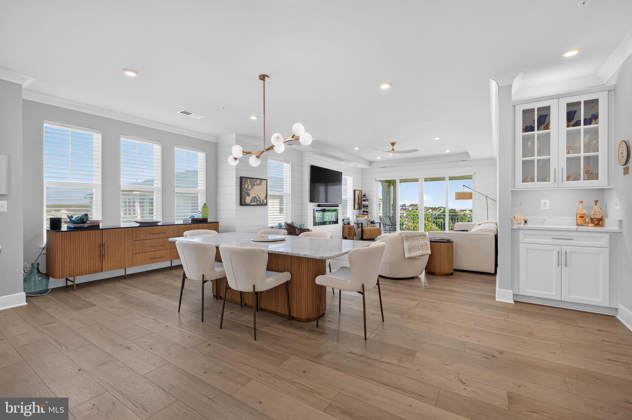 Welcome to this stunning 4th floor penthouse Severn condominium  with serene bay views! This end unit looks out over the walking trails to the water and trees.  The fabulous community center /pool / pier is a short 1 mile walk from your backyard.!  This unit also has the largest garage space in the the building, plenty of room for one car and storage, a refrigerator etc. There is also an additional inside storage room.  This 2600 Sq Ft home is flooded with natural light and has numerous quality upgrades including custom shiplap in most of the rooms, custom ceiling fans and dining room light fixture, custom built his and hers walk in closets. The primary bath has upgraded tile, shelving for more storage, mulitple shower heads and back and front lit vanity mirrors. The gourmet kitchen is designed to impress, featuring elegant quartz countertops,premium appliances and a Wolfe induction cooktop.  The island has been upgraded with shiplap as well.  Thoughtful upgrades continue throughout the entire home with custom blinds with remote control, a  gas fireplace,9 FT ceilings with tray ceilings in the living room and primary suite. A wet bar has also been added to the dining area.The large primary bedroom comes complete with a sitting area/office with exceptional waterviews.   It also offers  custom designed his -and -her closets that provide both style and storage. This unique residence offers a peaceful setting where you can relax and enjoy the ever-changing waterfront vistas. Whether you are enjoying your morning coffee or entertaining guests, this home offers the perfect blend of sophistication, comfort, and low maintenance waterfront living.