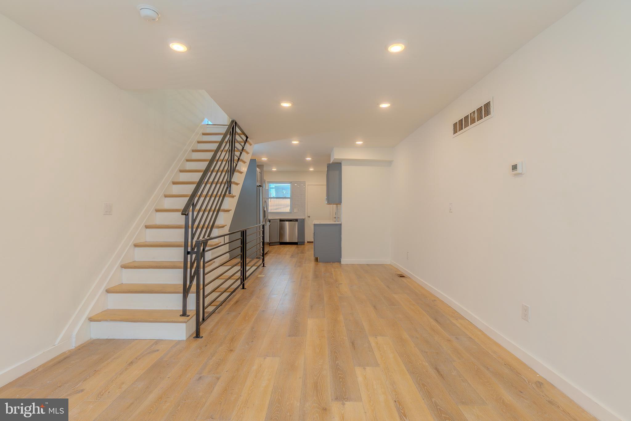 Fully remodeled in 2021, this thoughtfully updated home offers a stylish blend of modern finishes and practical comfort in every corner. From the moment you step inside, you're welcomed by durable and contemporary LVP flooring that flows throughout the main living spaces, setting the tone for a low-maintenance yet upscale lifestyle.

The kitchen is a standout, featuring striking marble countertops, a full four-piece stainless steel appliance set—all brand new—and ample cabinet space to meet your culinary needs. Whether you're hosting or preparing everyday meals, this space is as functional as it is beautiful. A convenient powder room on the main floor adds a thoughtful touch for guests.

Upstairs, enjoy dramatic 10+ ft ceilings that create an airy, open feel. Two generously sized bedrooms come complete with spacious closets, providing plenty of room to live and grow. The primary bath features a sleek double vanity and modern finishes, offering a spa-like experience right at home.

Downstairs, the fully finished basement expands your options—ideal for a home office, media room, gym, or bonus guest space. Stainless steel railings and other contemporary design elements continue the cohesive, elevated feel of the home.

Step outside to a fully fenced backyard, offering both privacy and plenty of room for entertaining, relaxing, or even gardening—an ideal retreat in the heart of the city.

With all-new appliances, updated systems, and modern touches throughout, this home is move-in ready and waiting for its next chapter. Don’t miss your opportunity to tour—schedule a showing today!