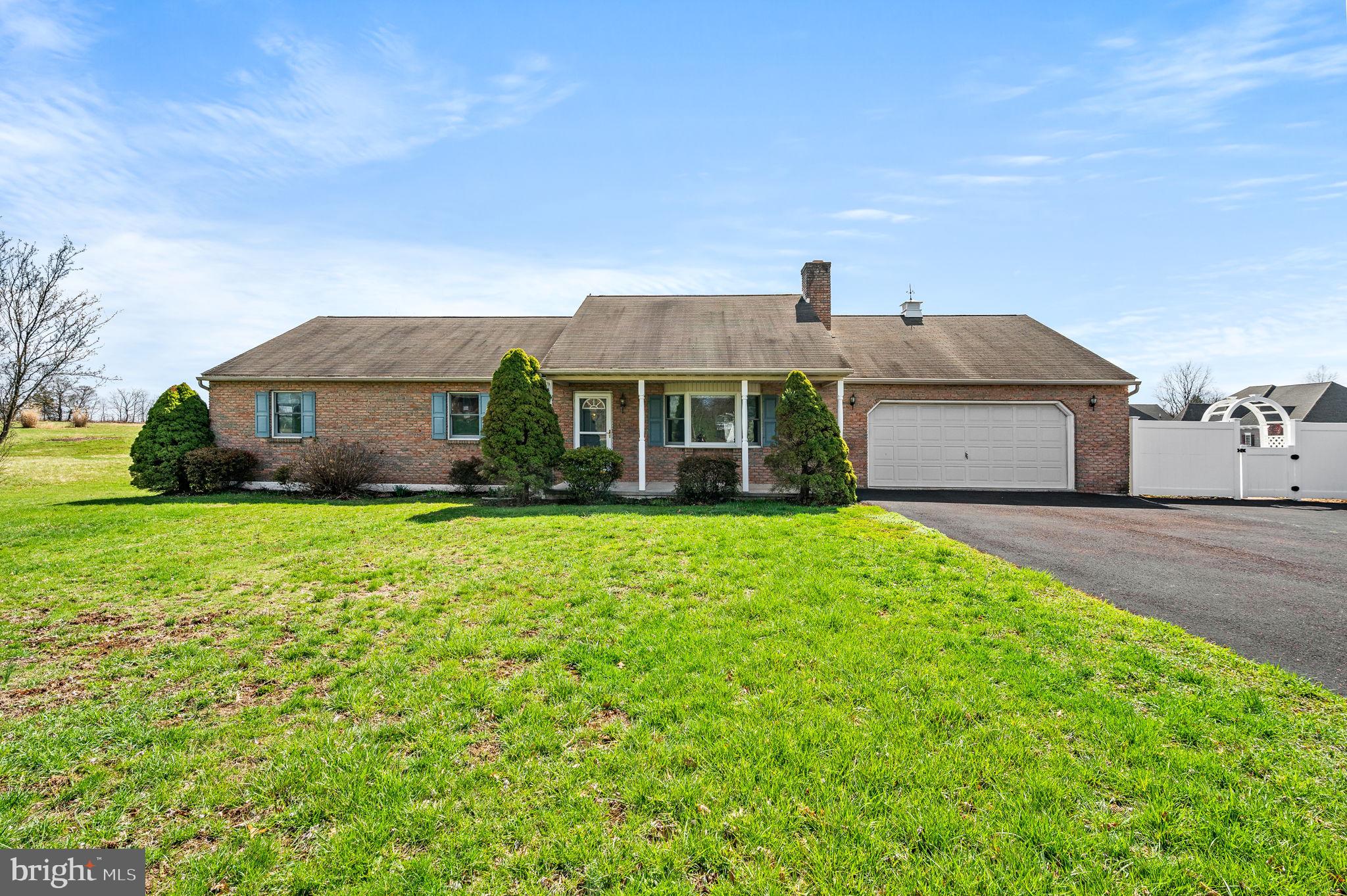 Beautiful and inviting, this spacious brick Ranch home is located on an attractive 1.1 acre Gilbertsville lot.  The extremely well-maintained home features over 3000 square feet of living space on 2 levels.   The main floor offers a large and welcoming Living Room with bay window and raised-hearth wood-burning fireplace; well-equipped Eat-In Kitchen; Dining Room; giant Sunroom affording great views of the large back yard; plus a separate 3-Season Room with pellet stove.  A Primary Bedroom Suite with a walk-in closet and full en suite Bathroom, two additional Bedrooms, a second full Bathroom in the hallway, and a Laundry Room are also on the first floor. Be prepared to be impressed with the expansive walk-out daylit lower level.  Entertaining on a large scale will be easy with the huge Family Room that features a wet bar/entertaining area.  A spacious Bonus Room (possible 4th Bedroom, Home Office, or Craft Room) and convenient powder room are also on this level. The entire home interior is freshly painted and brand-new carpeting is throughout the finished basement.  The oversized 2-car Garage features a workstation, utility sink, and sought-after staircase providing convenient access to  extensive floored attic space. A detached 12x24 workshop/shed with overhead door is ideal for all sorts of projects and activities.  You will enjoy outdoor entertaining and recreation on the welcoming front porch, covered rear patio (15’x23’) and open lawn areas.  Great location close to parks, shopping, and major commuter routes.  This generously sized rancher with quality details is truly in move-in condition.