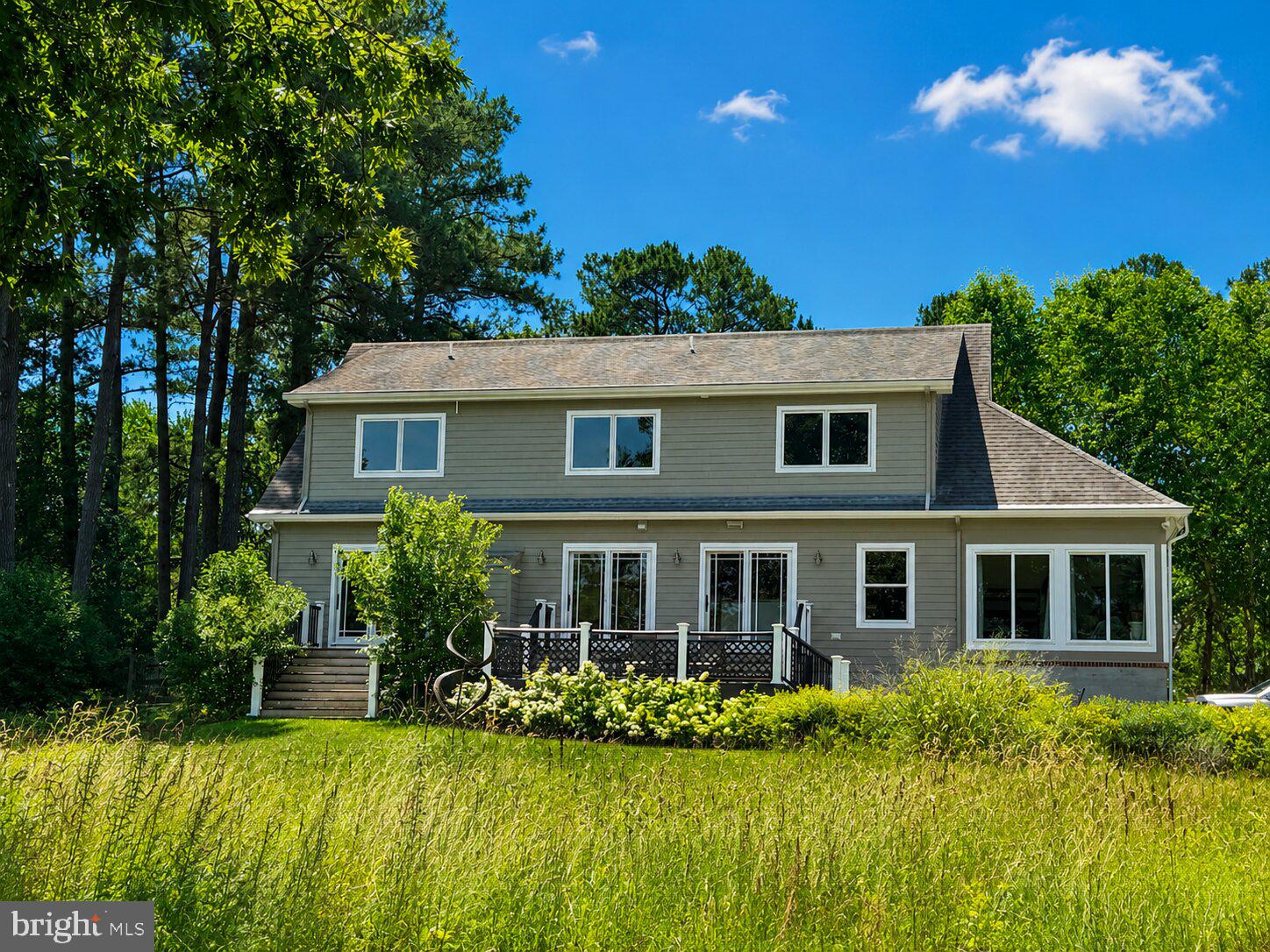 If you are one who expects the unexpected, this waterfront property in Easton will not disappoint. From the one-hundred-year-old oak standing sentinel over Peachblossom Creek to the 42 solar panels creating minimal power bills, this “issue free” home is unexpected, if not actually startling. Ideally located along the desirable Oxford Road corridor, the property offers convenient access to both Easton and Oxford while providing a peaceful waterfront setting on Peachblossom Creek. Designed for comfortable one-floor living and a low-carbon footprint, you can expect a lifetime of enjoyment. This 4-bedroom,2 1/2 -bath home features beautiful wood floors throughout, an eat in  kitchen, with abundant storage space. A huge attached garage provides even more room for vehicles, hobbies, and storage. There’s even a hot tub! A yard implemented by an expert environmental gardener creates a haven for birds (more than 80 different types of birds can be found here) that is less maintenance—and more attractive to neighbors—than the oh, so very common “all lawn” approach. Watch bluebirds and herons while you sip your morning coffee from the expansive Azek deck overlooking the water. Smile at lightning bugs flitting about the yard as you watch the stars come out at night. The open floor plan and large windows keep the home full of light and allow endless views of the water. State-of-the-art solar with 2 large Tesla storage batteries,, whole house  water purification system, and HVAC systems make for healthy living, too. A denitrifying septic system  for up to 6 bedroom, helps keep the Bay clean—in fact, this home's low carbon footprint and thoughtfully designed landscape actually help the environment. An unforeseen property, even if you expect the unexpected. Beautiful sun porch with separate HVAC mini split. Several walk- in storage areas, plus huge unfinished space over garage. Hot Tub and extra freezer convey. Whole house surge protector.