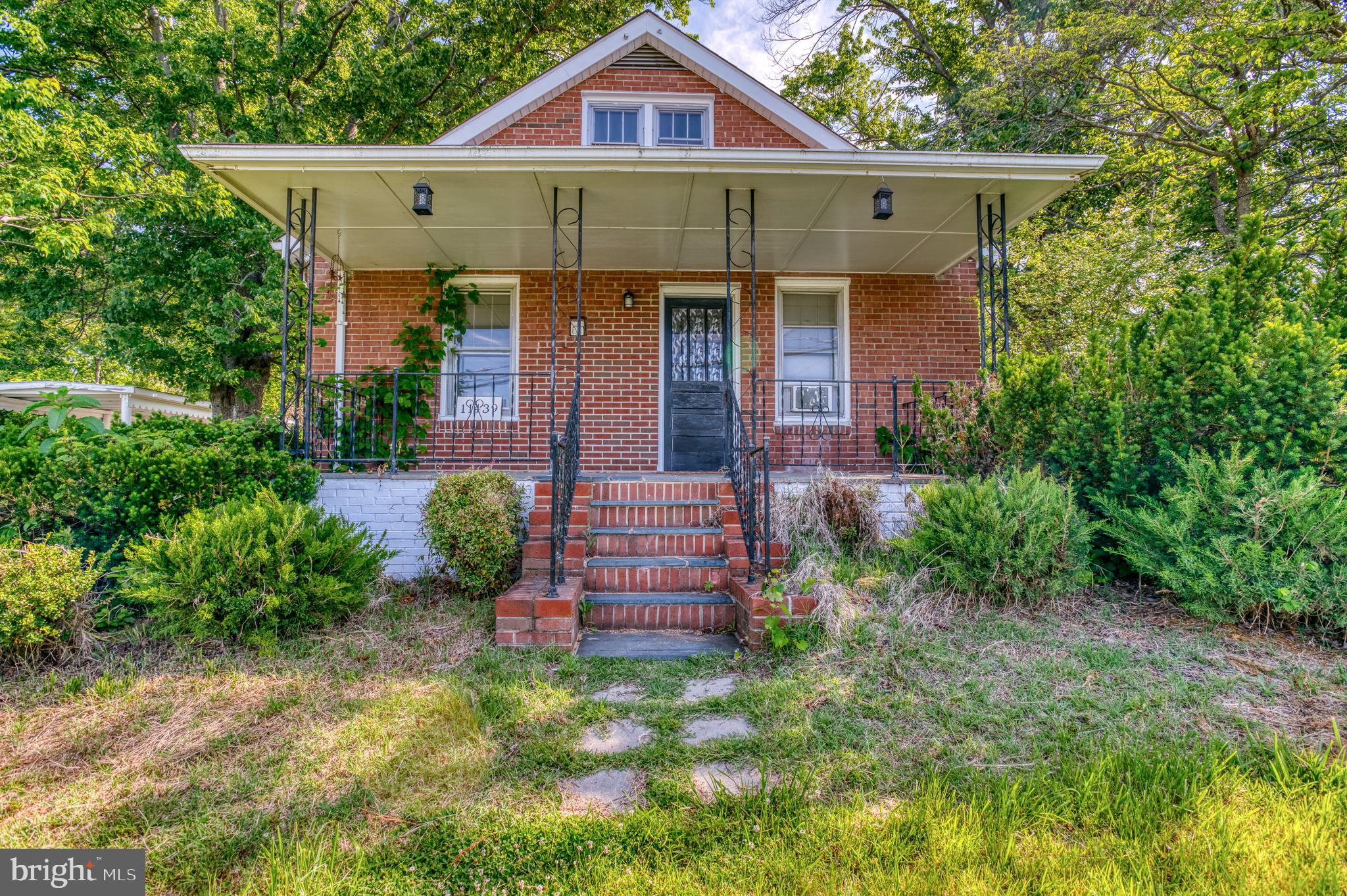 Charming 3BR/2BA bungalow just minutes from historic downtown, full of character, potential, and opportunity! Nestled on a spacious lot with mature trees, this home offers a welcoming setting with a large private rear yard perfect for gardening, entertaining, outdoor living, or future expansion possibilities. Relax on the inviting front porch or unwind on the rear patio while enjoying the peaceful surroundings.

Inside, you’ll find beautiful hardwood floors throughout and a bright living room filled with natural light. The updated eat-in kitchen features granite countertops, updated cabinetry, abundant storage, and plenty of prep space for everyday living and gatherings. The flexible floor plan includes a main-level bedroom with access to a full bath, along with convenient main-level laundry. Upstairs offers additional bedrooms, a full bathroom, and a spacious sitting room that could serve as a home office, playroom, hobby space, or future primary suite retreat.

Kitchen and bathrooms were renovated in 2019, providing a great foundation to build upon. Solidly built with tons of charm and endless potential for someone ready to add their own finishing touches and make it shine again. A wonderful opportunity for homeowners, investors, or buyers looking for a property with possibilities in a convenient location close to shopping, dining, and all that downtown has to offer.