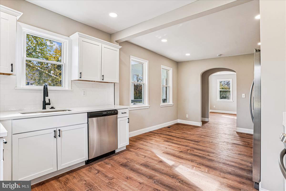 This exquisite single family home seamlessly blends classic charm with modern luxury. Nestled on over an acre of lush grounds, the home boasts 5 spacious bedrooms and 3 and a half elegantly appointed bathrooms, including a primary suite with a luxurious walk-in shower and walk-in-closet.  The heart of the home features a beautifully designed eat-in kitchen, complete with quartz countertops and stainless steel appliances, perfect for culinary enthusiasts and entertaining guests. Natural light floods the open area, enhanced by recessed lighting that creates a warm ambiance. Cozy up by the fireplace in the inviting living room, or retreat to the fully finished basement for additional leisure and living space. With ample storage, including walk-in closets, and convenient entry-level bedrooms, this home offers both comfort and functionality;. Experience a lifestyle of elegance and ease in this property, where almost everything is new and every detail invites you to create lasting memories. Call helpful agent with questions.