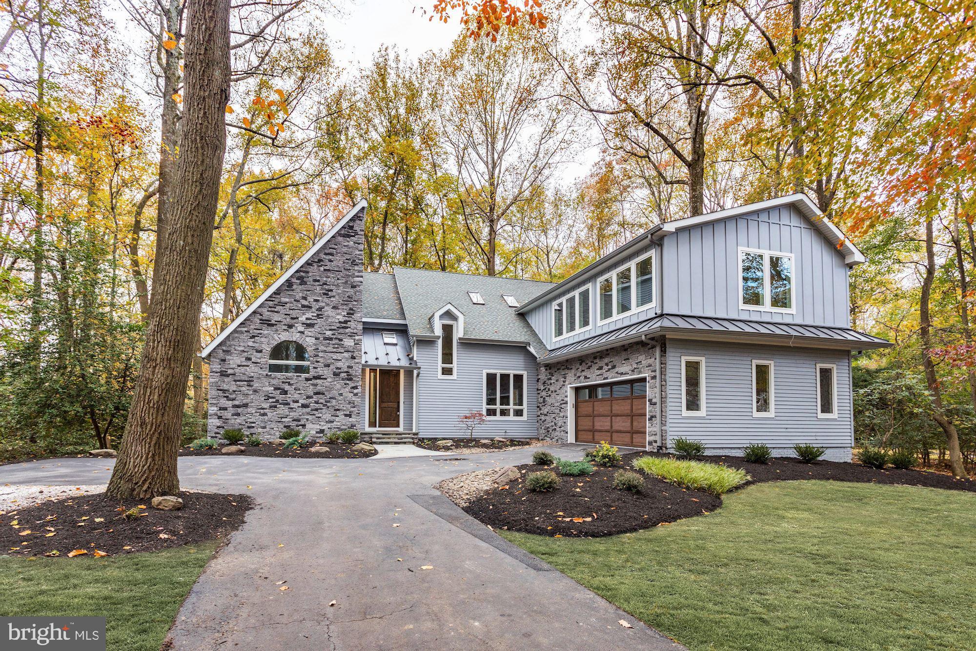 Set in sought-after Bay Ridge, this stunning residence welcomes you with a dramatic stacked stone and fiber cement exterior, nestled against a tree lined lot. Enjoy the luxurious waterfront community amenities including a swimming pool, Clubhouse, boat ramp, beaches, and more, or take advantage of the natural setting of the home as sun-kissed floor-to-ceiling windows bring the outside in. An open concept layout, embellished with classic hardwoods and soaring ceilings, allows for effortless entertaining and easy everyday living. A vaulted ceiling with skylights, picture windows with panoramic views, and an ambient fireplace with a cedar shiplap fa ade embellish the great room while the lavish kitchen is sure to be the heart of the home. Appointed with stainless steel appliances including dual ovens, a six-burner stove, range hood, and a beverage cooler, along with quartz countertops, subway tile backsplash, custom cabinetry, center island, and breakfast area, this kitchen is sure to be the envy of any guest. For formal gatherings, your elegant dining room is ideally located off the kitchen. Down the hall, the opulent master beckons you for ultimate comfort with dual walk-in closets, a private deck, and a luxurious master bath featuring a pedestal tub, frameless glass shower, and separate vanities. Hardwoods ascend to the loft, an ideal office for the modern business person, while four additional bedrooms, along with two full baths, complete the upper level. For additional leisure and entertaining, the sprawling recreation room awaits endless possibilities while barn doors separating a den and full bath present an opportunity for an ideal guest suite. Whatever your lifestyle entails, this turnkey home is ready for memories to come!